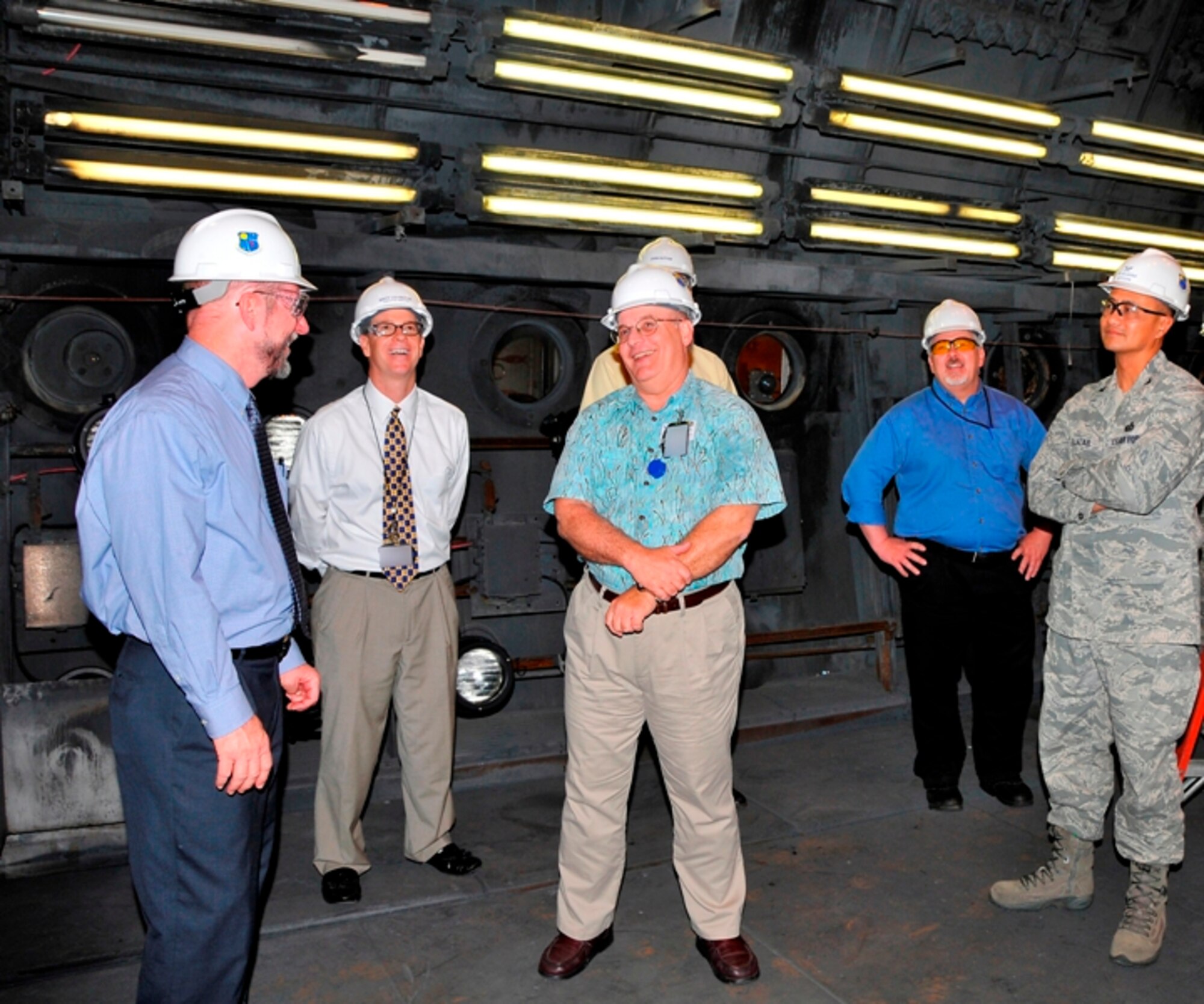 Dr. Davy Belk, AFFTC’s executive director at Edwards AFB, Britt Covington, AEDC executive director, Randy Quinn, Rocket Test capability manager, John Sutton, AEDC director of contracting, Chris Smith, AEDC’s technical director of the Space and Missile Ground Test Complex, and Col. Geoffrey Ellazar, Jr, AFFTC director of contracting, share a lighter moment while touring a test cell at AEDC’s Rocket Development Test Cell J-6 Facility.