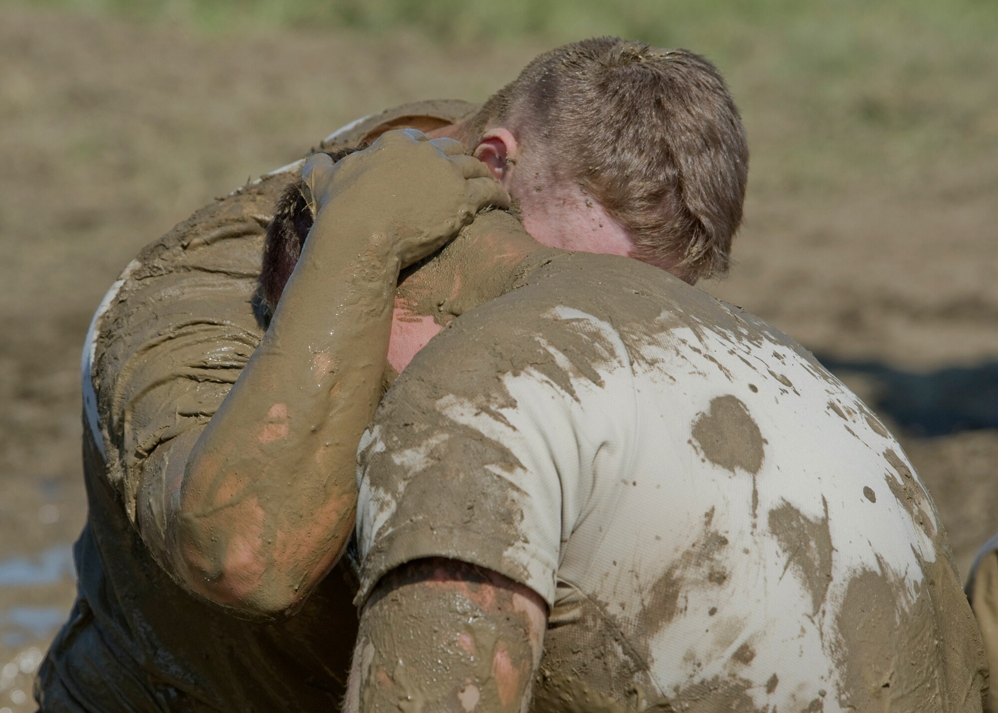 2nd Lt. Michael Bruton, 341st SFS member, left, gives Airman 1st Class Derek Marris, 341st SFS member, words of encouragement after completing the push-ups at the team pain station during the Aces Cop Combat Challenge on May 11. (U.S. Air Force photo/Beau Wade)