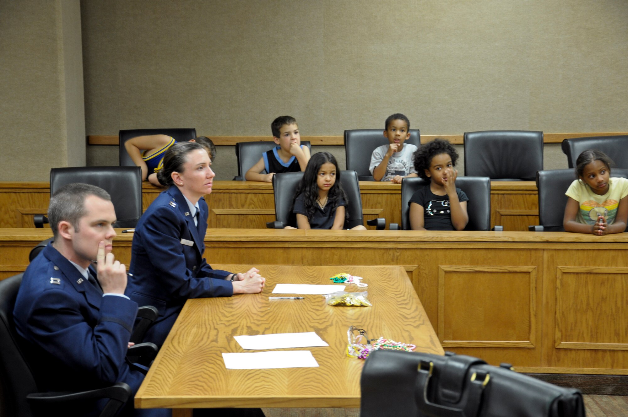 Children listen to the testimony of a man accused of robbing a jewelry store May 9 during the 56th Fighter Wing Judge Advocate office law day. The children got an opportunity to see how the court system works. They also participated in a mock trial where they voted the accused guilty.  (U.S. Air Force photo by Senior Airman C.J. Hatch)