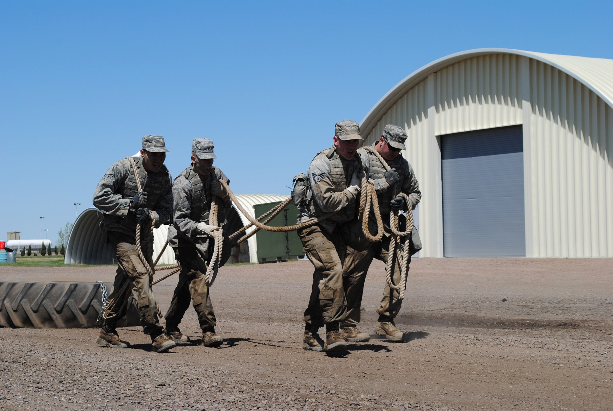 Members of Team 43 pace themselves at the tire-pull station at the Warrior Launch Facility May 11. From left are Airman 1st Class Kevin Kamakahi, 341st Missile Security Forces Squadron; 2nd Lt. Michael Voto, 341st MSFS flights commander; Senior Airman Aaron Foster, 341st MSFS member; and Senior Airman Brandon Lococo, 341st MSFS member. Team 32 completed eight repetitions at the tire-pull station in 15 minutes. (U.S. Air Force photo/Airman 1st Class Katrina Heikkinen)