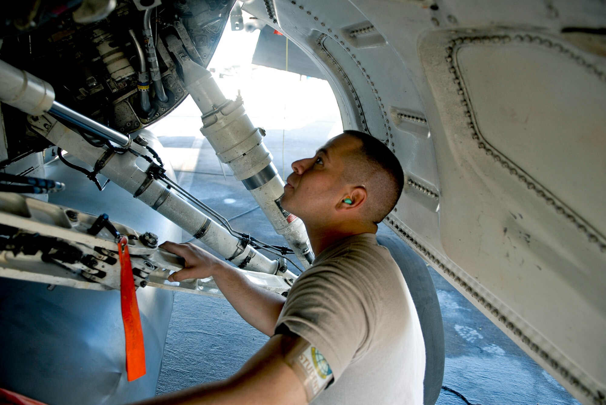 Airman 1st Class Ross Magedoff, Detachment 12, 372nd Training Squadron Tactical Aircraft Maintenance specialist, inspects components inside the landing gear of an F-16 April 24 on Luke Air Force Base. He graduated from Det. 12’s crew chief training course April 27, certifying as a new crew chief on the F-16 Fighting Falcon. The students’ time at Luke maintaining any one of the 56th Fighter Wing’s 138 F-16s marks the first time they work on jets that are heading out for actual training missions. Their previous experience is on decommissioned jets that no longer flew used only for training.  (U.S. Air Force photo by Senior Airman C.J. Hatch)