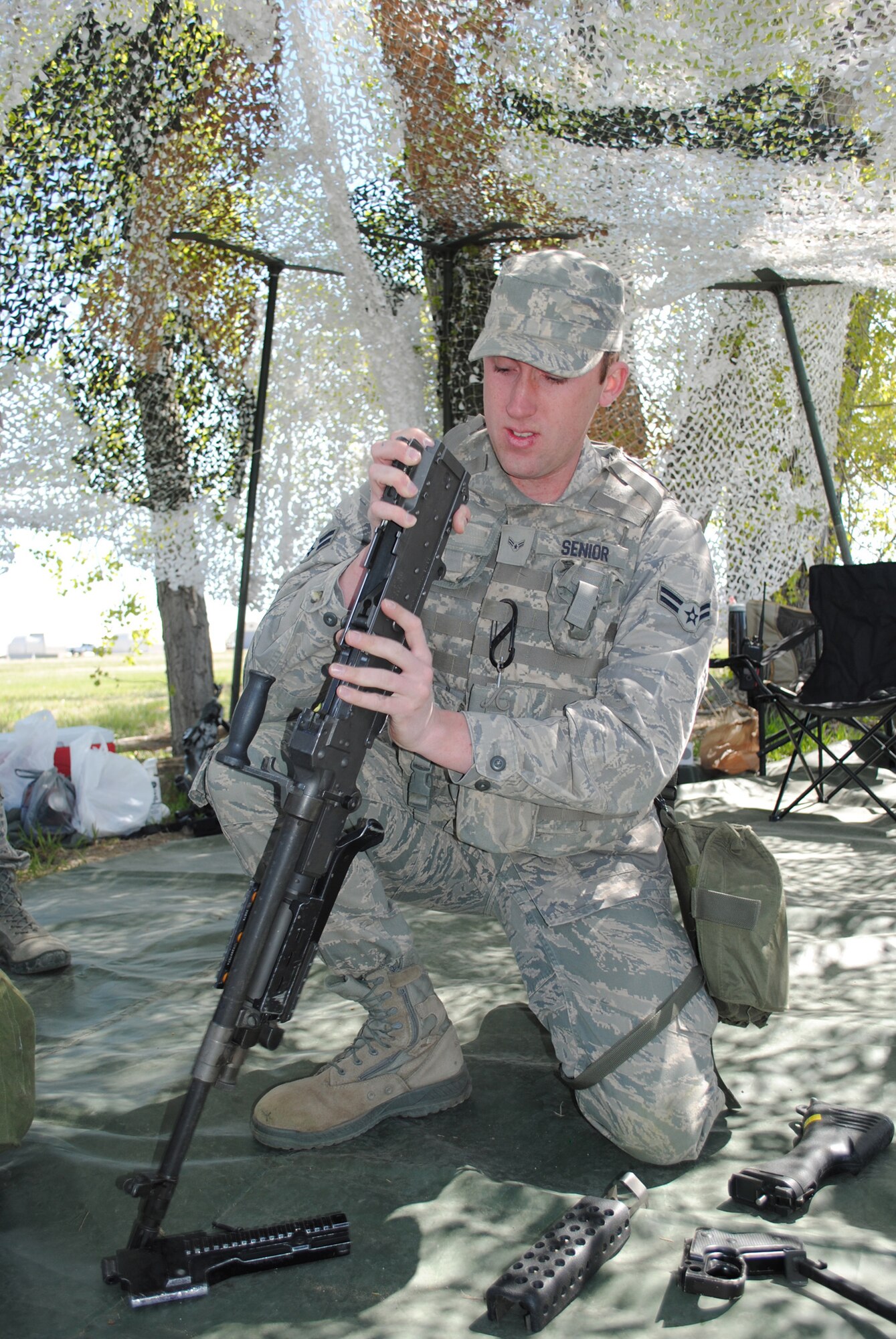 Airman 1st Class Daniel Senior, 341st Missile Security Forces Squadron member, works on taking apart an M240 at station 24 called Box of Guns while the rest of his group takes apart an M4and M249. (U.S. Air Force photo/Airman 1st Class Katrina Heikkinen)
