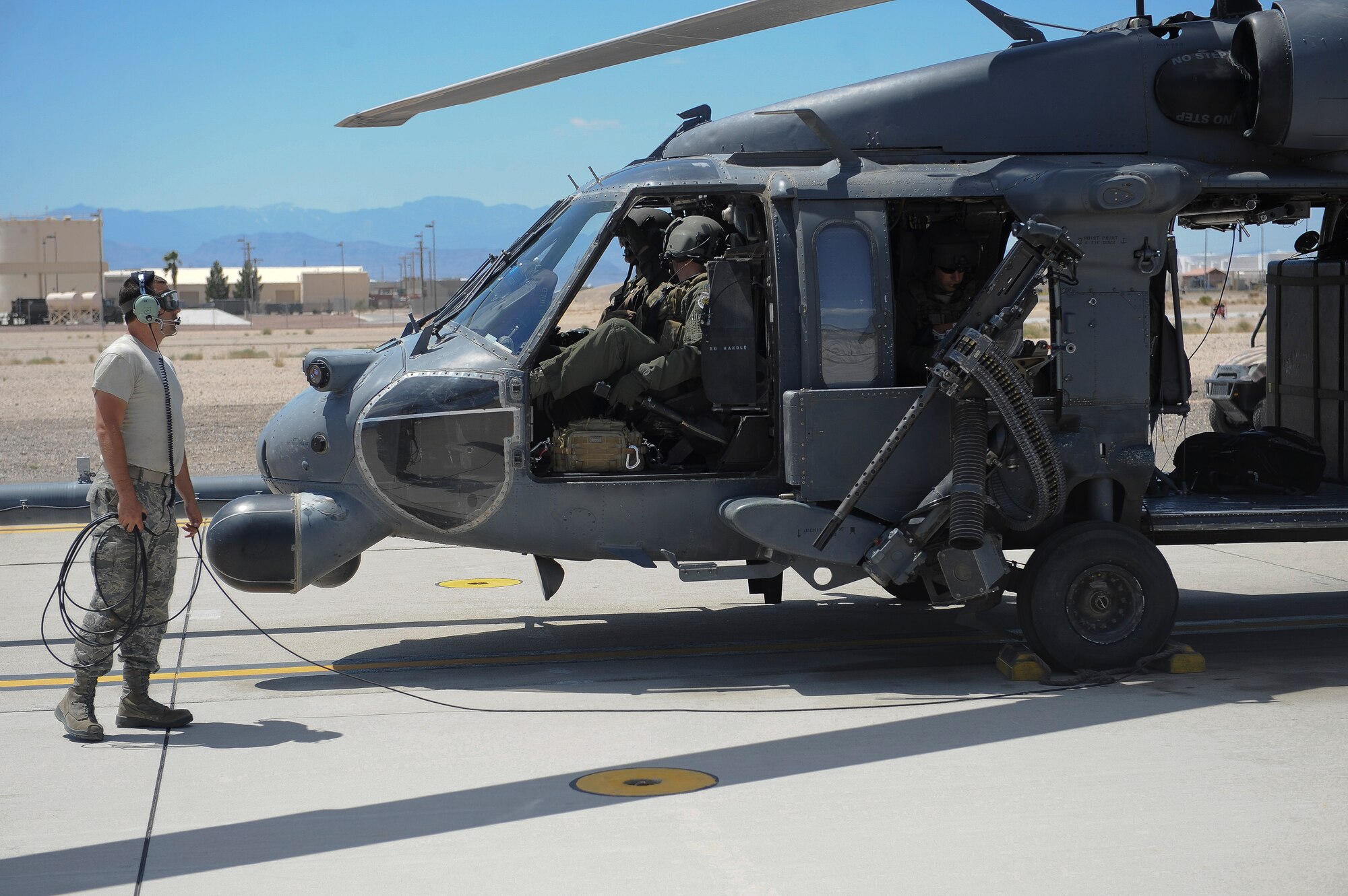 U.S. Air Force Airman 1st Class Christopher Malvagna, 823d Maintenance Squadron crew chief, completes a preflight check at Nellis Air Force Base, Nev., May 7, 2012. Col. Billy Thompson, 23d Wing commander and Chief Master Sgt. Frank Batten, 23d Wing command chief, flew with the 66th Rescue Squadron while visiting Nellis. (U.S. Air Force photo by Staff Sgt. Ciara Wymbs/Released)  