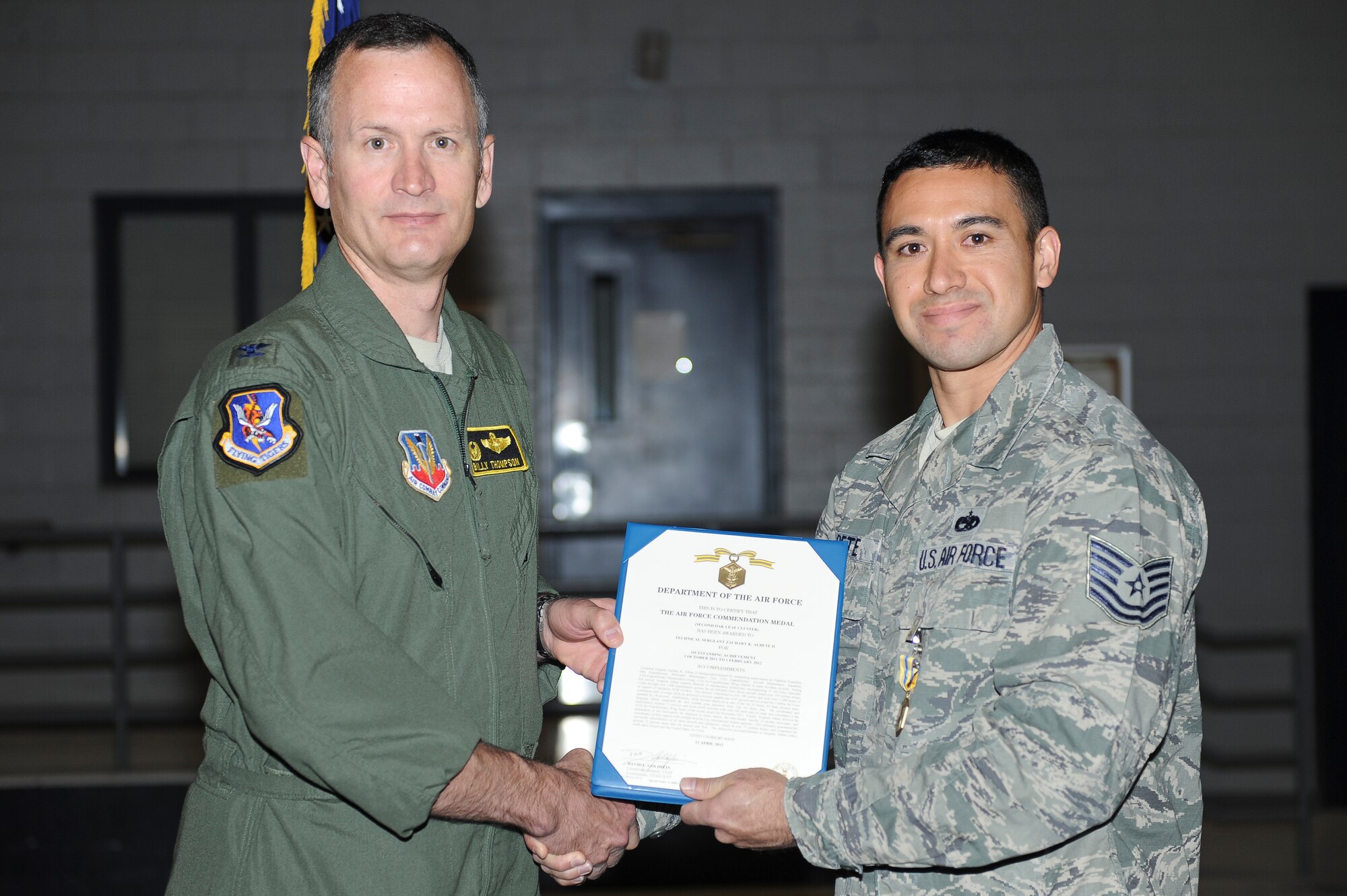 U.S. Air Force Col. Billy Thompson, 23d Wing commander, presents the Air Force Commendation Medal to Tech. Sgt. Zachary Albete, 823d Maintenance Squadron HH-60G Pave Hawk expeditor, at Nellis Air Force Base, Nev., May 7, 2012. Albete received the medal for his actions and hard work during a deployment to Kuwait supporting Operation New Dawn. (U.S. Air Force photo by Staff Sgt. Ciara Wymbs/Released)