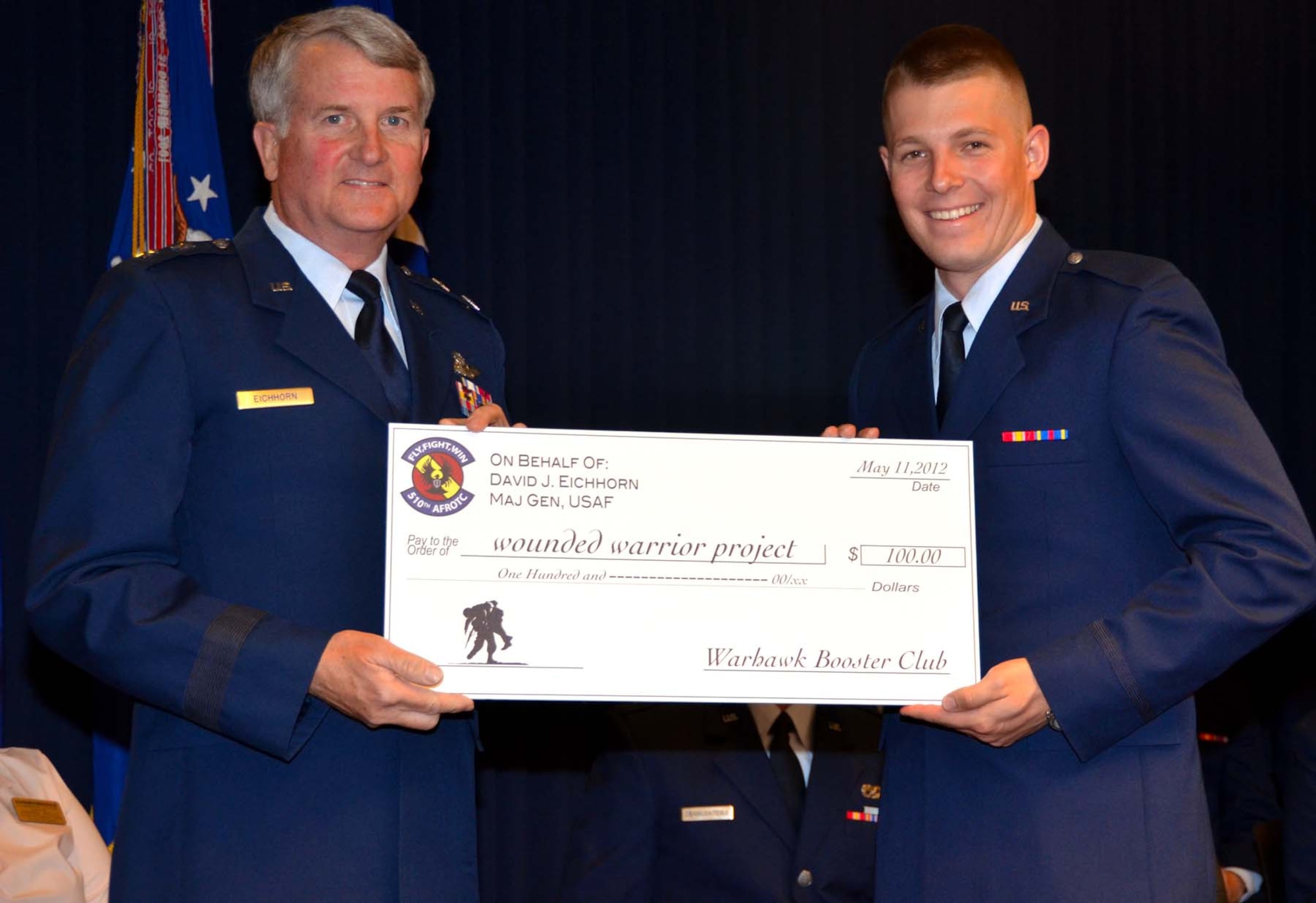 Cadet Eric Estvanko, from the University of New Mexico Air Force ROTC Detachment 510, presents guest speaker Maj. Gen. David J. Eichhorn, Air Force Operational Test and Evaluation Center Commander, a donation to the Wounded Warriors Project in his name in appreciation for attending and speaking at the May 11, 2012 UNM Air Force commissioning ceremony held at AFOTEC headquarters on Kirtland AFB, N.M.