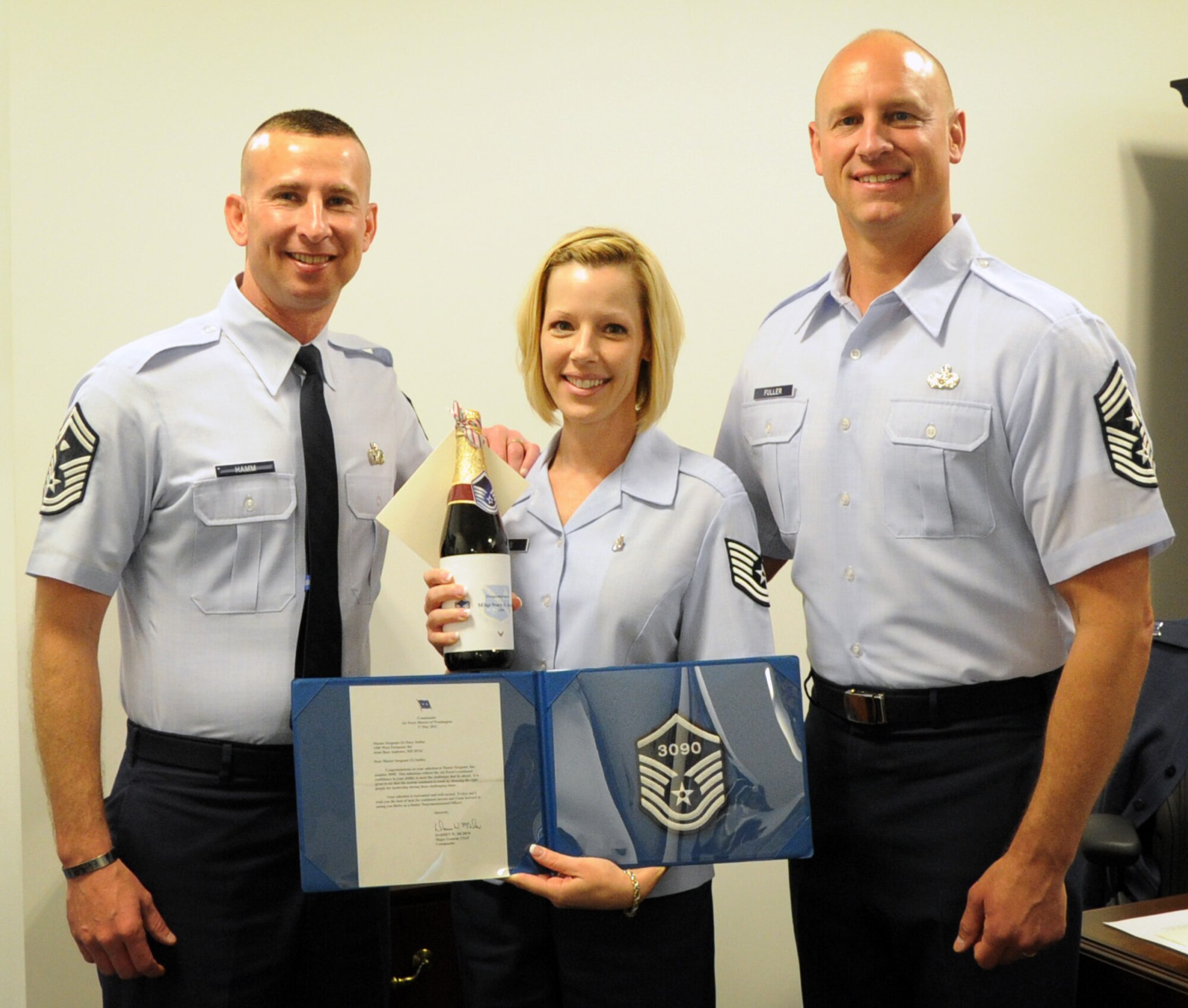 Master Sgt. select Stacy Settles, Air Force District of Washington command staff executive assistant, celebrates her achievement May 17 with AFDW Command Chief Master Sgt. Scott A. Fuller and AFDW First Sergeant Senior Master Sgt. Johnny L. Hamm on Joint Base Andrews, Md.  The AFDW senior leaders congratulated each selected technical sergeant for their achievement. AFDW gained six new senior NCOs from the 5,464 technical sergeants selected for promotion to master sergeant. (U.S. Air Force photo by Airman 1st Class Tabitha N. Haynes)