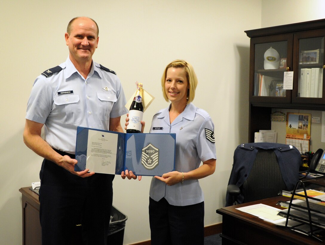 Master Sgt. select Stacy Settles, Air Force District of Washington command staff executive assistant, celebrates her achievement May 17 with AFDW Vice Commander Col. Jeffrey L. Stephenson on Joint Base Andrews, Md. The AFDW senior leaders congratulated each selected technical sergeant for their achievement.  AFDW gained six new senior NCOs from the 5,464 technical sergeants selected for promotion to master sergeant. (U.S. Air Force photo by Airman 1st Class Tabitha N. Haynes)