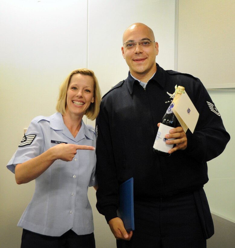 Master Sgt. select Stacy Settles, Air Force District of Washington command staff executive assistant, celebrates May 17 with Master Sgt. select Kenneth Boria, AFDW protocol, on Joint Base Andrews, Md. The AFDW senior leaders congratulated each selected technical sergeant for their achievement.  AFDW gained six new senior NCOs from the 5,464 technical sergeants selected for promotion to master sergeant. (U.S. Air Force photo by Airman 1st Class Tabitha N. Haynes)