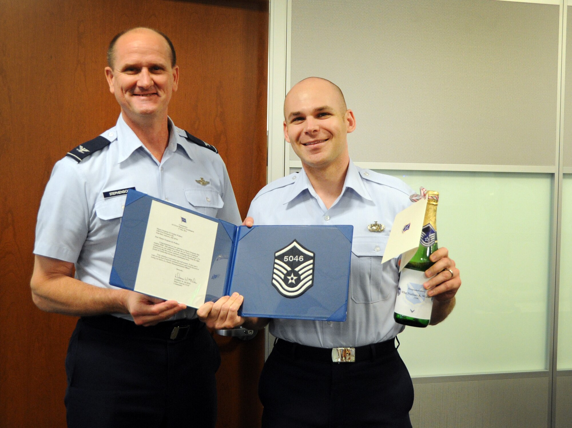 Master Sgt. select Nathan Wallace, Air Force District of Washington contracting, celebrates his achievement May 17 with AFDW Vice Commander Col. Jeffrey L. Stephenson on Joint Base Andrews, Md. The AFDW senior leaders congratulated each selected technical sergeant for their achievement.  AFDW gained six new senior NCOs from the 5,464 technical sergeants selected for promotion to master sergeant. (U.S. Air Force photo by Airman 1st Class Tabitha N. Haynes)