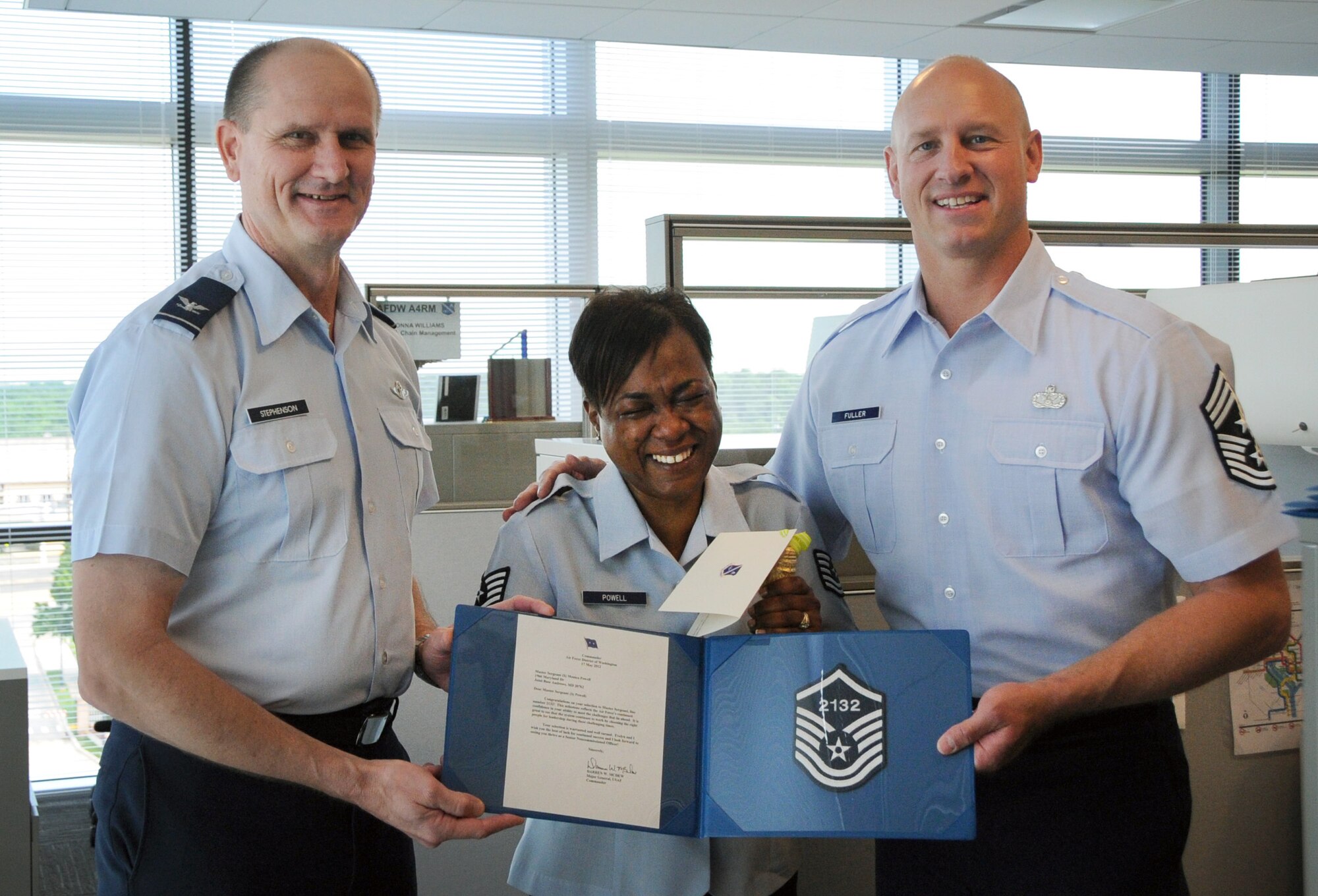 Master Sgt. select Monica Powell, Air Force District of Washington logistics, fights tears of joy May 17 when AFDW Vice Commander Col. Jeffrey L. Stephenson and AFDW Command Chief Master Sgt. Scott A. Fuller congratulated her for her achievement on Joint Base Andrews, Md.  AFDW gained six new senior NCOs from the 5,464 technical sergeants selected for promotion to master sergeant. (U.S. Air Force photo by Airman 1st Class Tabitha N. Haynes)