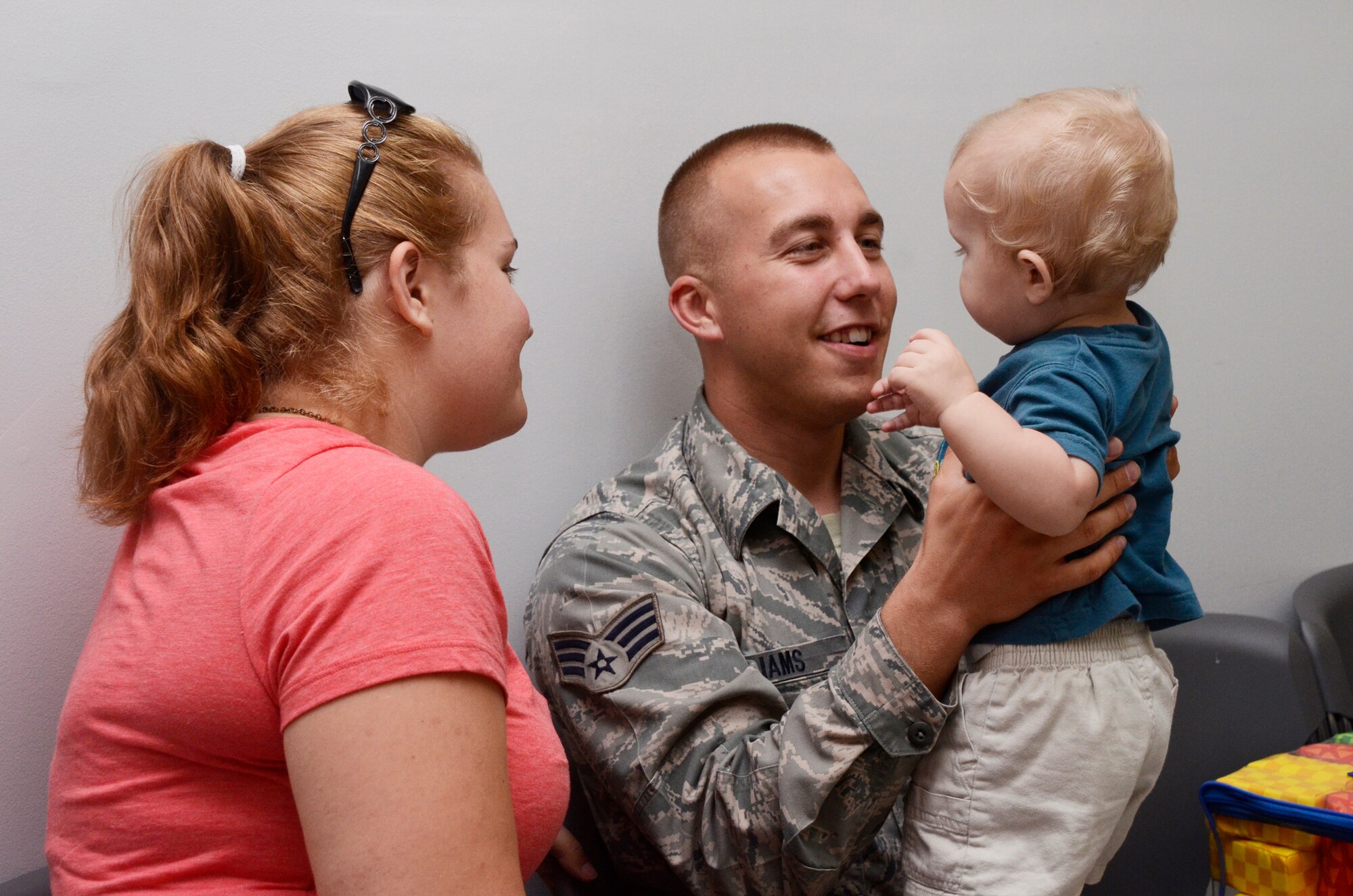Back from his Middle East deployment, Senior Airman Allen Williams from the 80th Aerial Port Squadron receives a hero’s welcome from family during his return home reception held here May 17. (U.S. Air Force photo/Don Peek)
