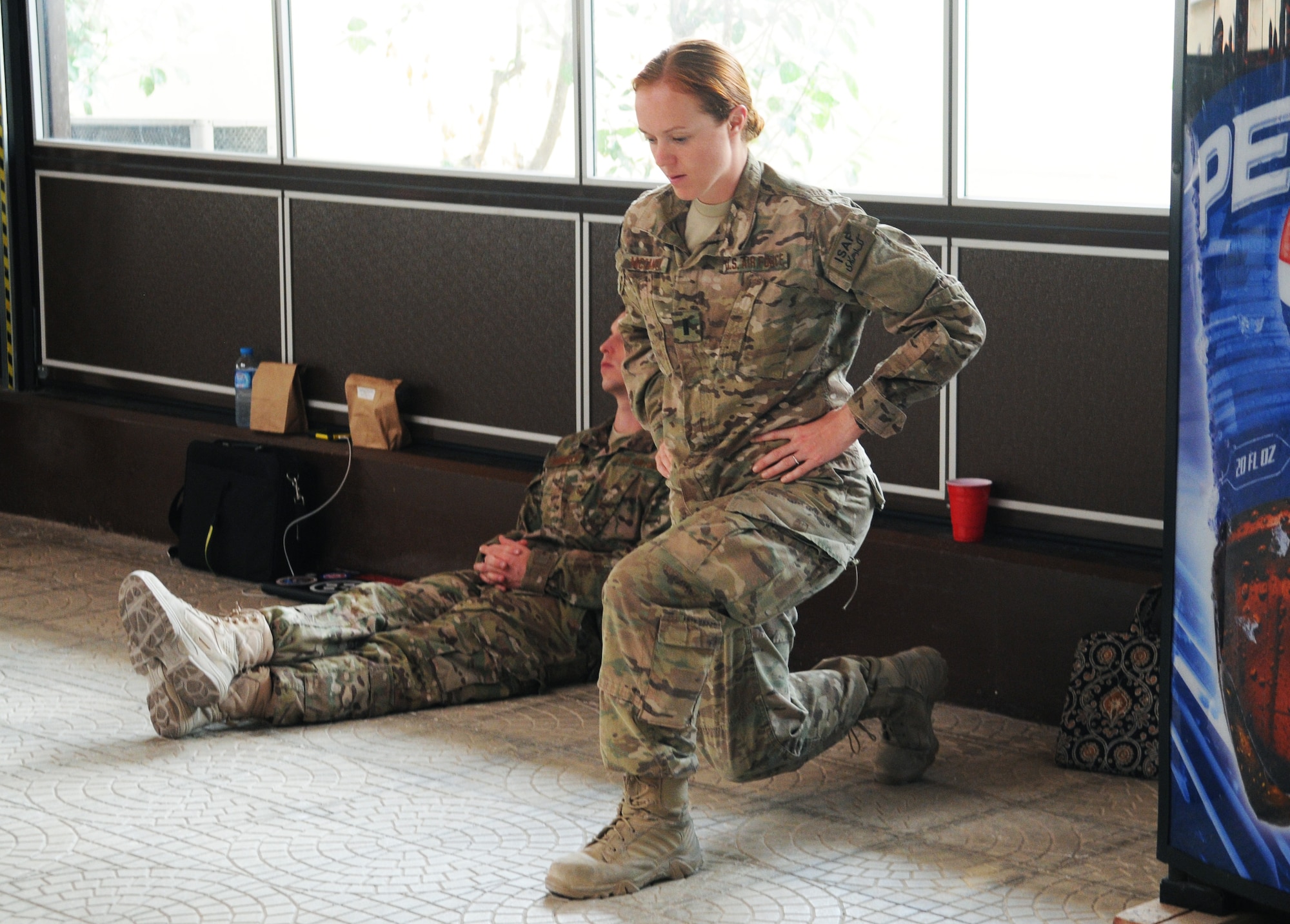 An Airman performs lunges to stretch her legs while on a layover May 12, 2012, at Incirlik Air Base, Turkey. More than 250 redeploying service members received snacks and drinks as part of Operation First Stop, a community service project created to welcome home redeploying service members who transit through Incirlik on their way back to the U.S. (U.S. Air Force photo by Senior Airman Marissa Tucker/Released)
