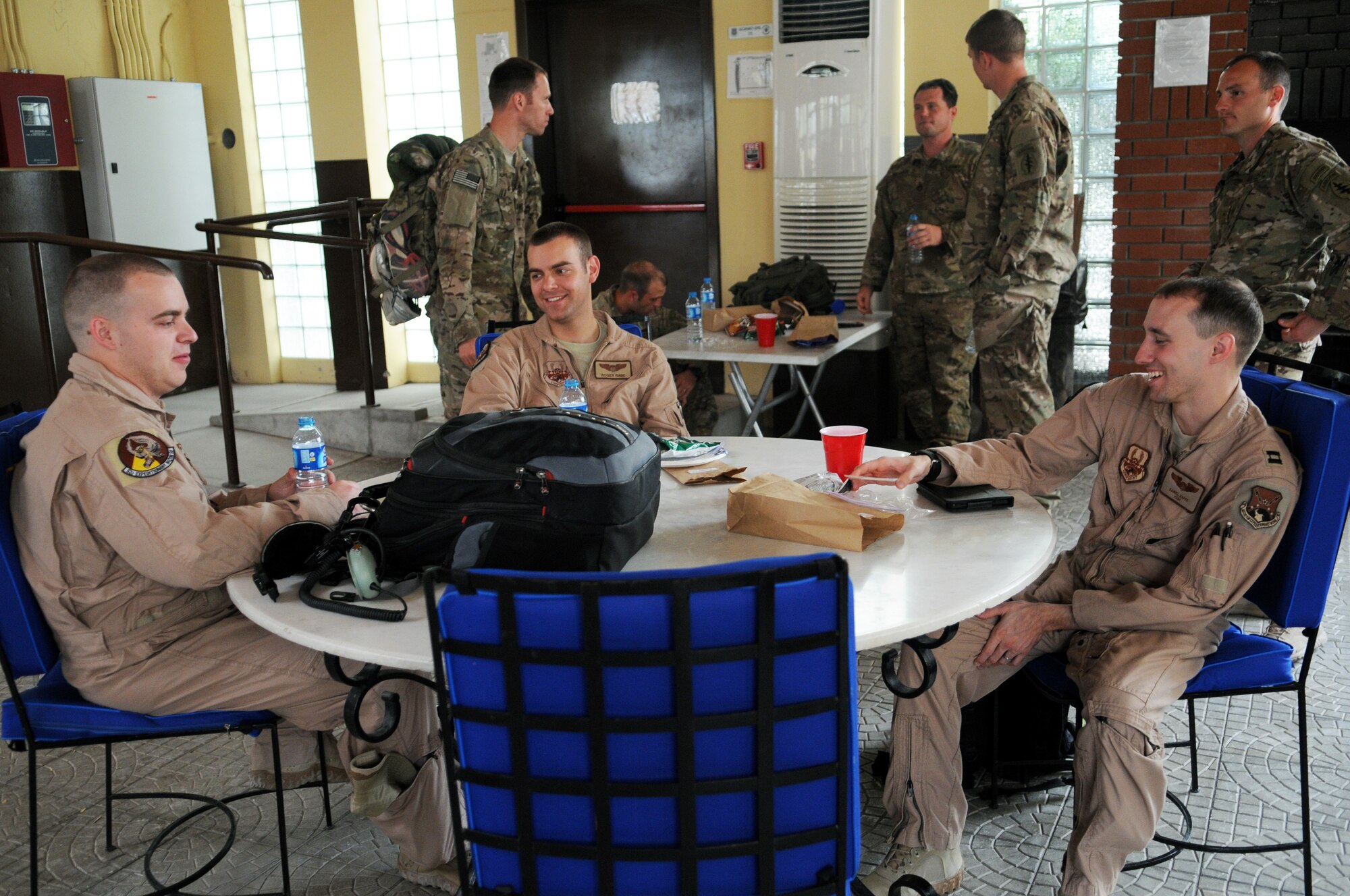 Redeploying aircrew members share a laugh after receiving drinks and snacks provided by Operation First Stop while on a layover May 12, 2012 at Incirlik Air Base, Turkey. Operation First Stop is a community service project created by Incirlik Airman Leadership Class 12-D to provide snacks and drinks to redeploying service members traveling though Incirlik. (U.S. Air Force photo by Senior Airman Marissa Tucker/Released)


