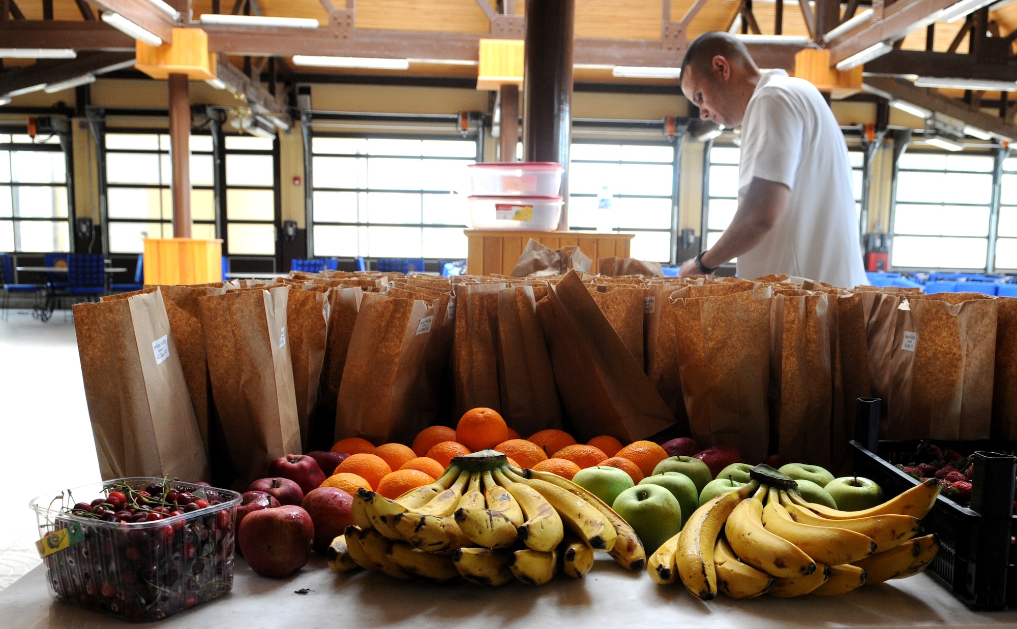 Tech. Sgt. Kitsana Dounglomchan, Incirlik Airman Leadership School instructor, arranges bags of chips and cookies to be distributed to redeploying service members as part of Operation First Stop May 12, 2012, at the passenger terminal on Incirlik Air Base, Turkey. Operation First Stop is a community service project created by ALS Class 12-D to provide snacks and drinks to redeploying service members traveling though Incirlik. (U.S. Air Force photo by Senior Airman Marissa Tucker/Released)

