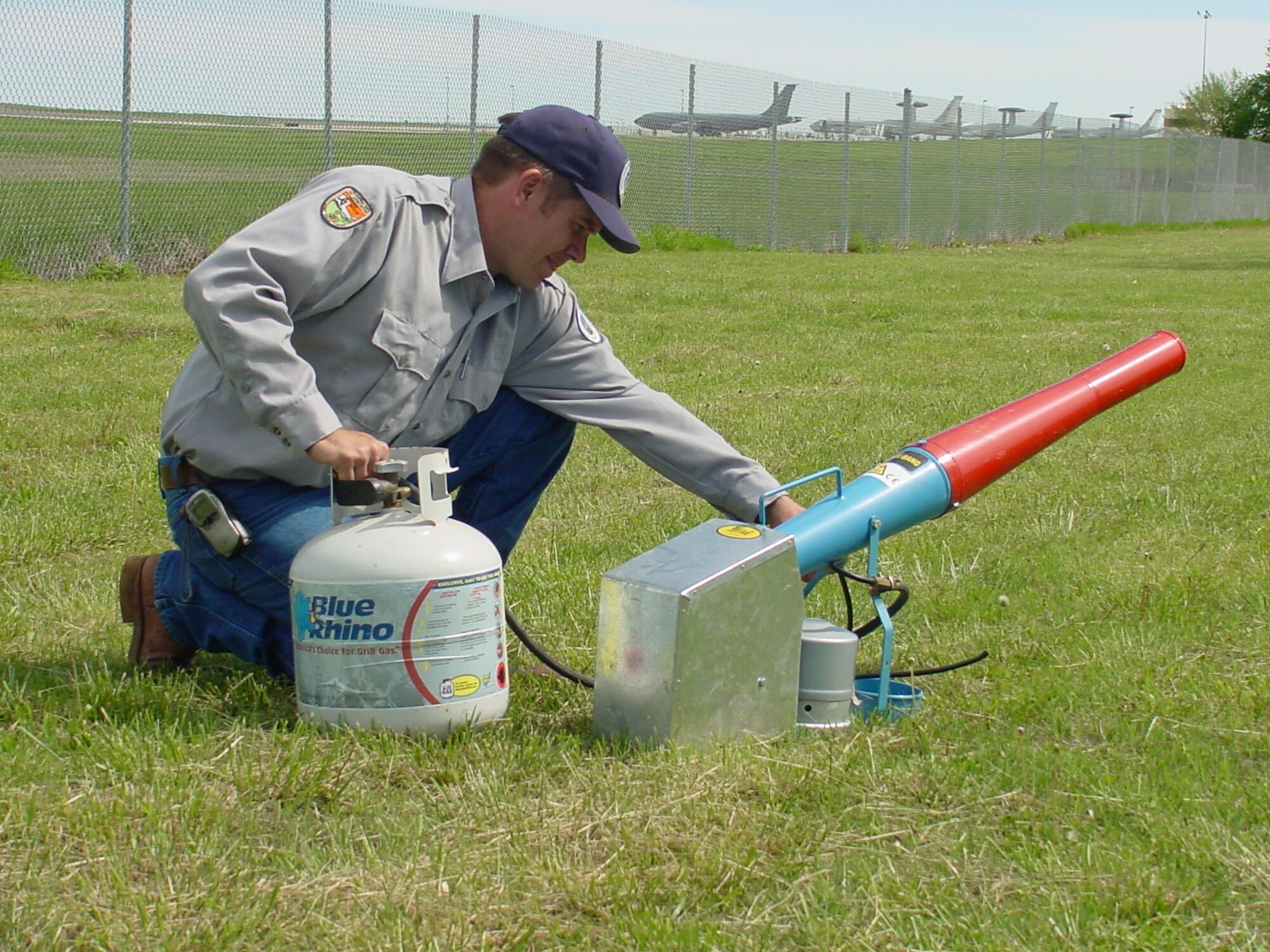 Clarke Baker, a wildlife biologist with the U.S. Department of Agriculture’s Wildlife Services, prepares a propane cannon employed to scare birds gathered near the Tinker AFB flight line. The cannon is one of several non-lethal hazing techniques intended to prevent bird strikes. (Courtesy photo)