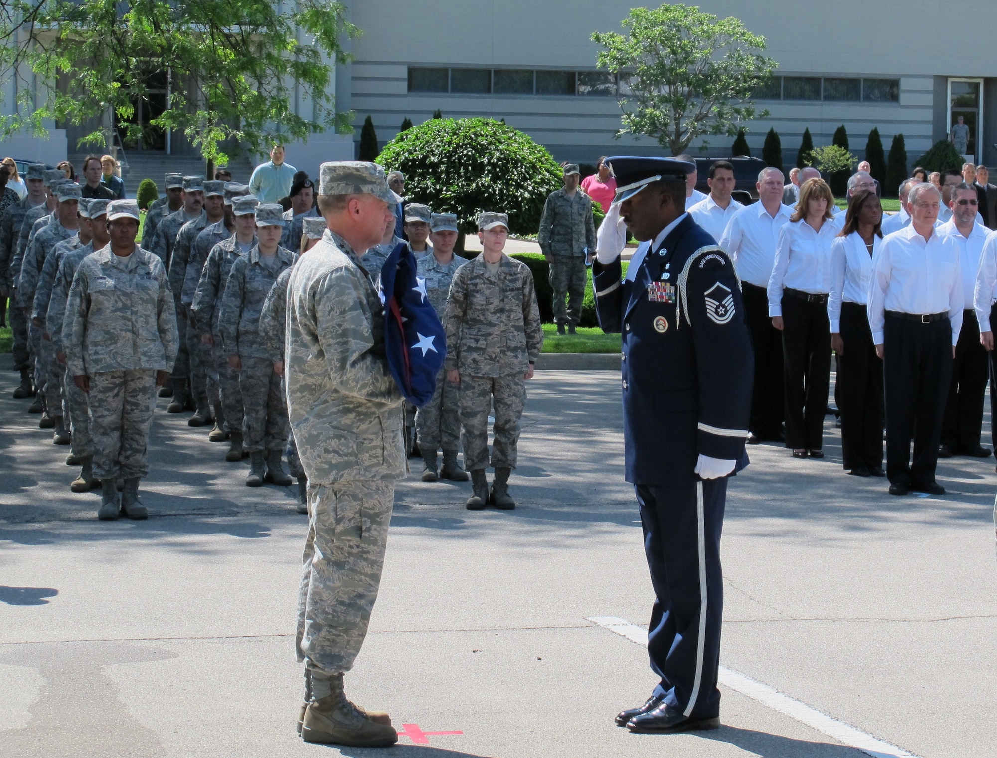 Gen. Donald Hoffman, commander of Air Force Material Command, is saluted by a member of the base honor guard after accepting the flag at his final retreat ceremony May 17, 2012.  The two were flanked by formations of AFMC military members and civilian employees. Hoffman will end a 42-year Air Force career when he retires June 5. (Air Force photo/Ron Fry)
 
