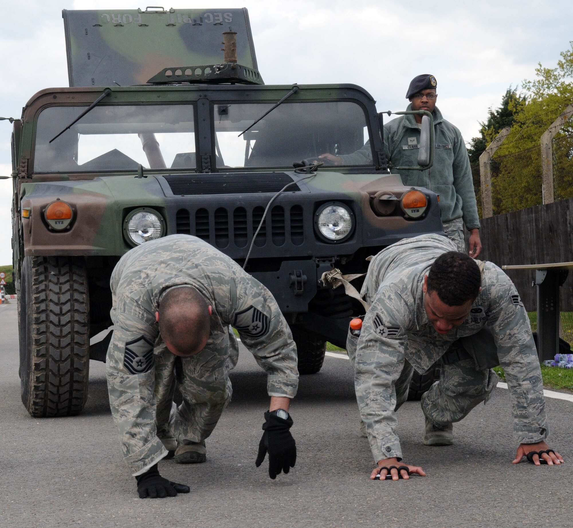 RAF MILDENHALL, England – Master Sgt. Jason Hallmon and Senior Airman Brandon Burress, 100th Security Forces Squadron, pull a Humvee during the Defender Challenge May 16, 2012, here. Six teams competed in seven different challenges to help build up Airmen’s mental and physical endurance. (U.S. Air Force photo/Senior Airman Rachel Waller)