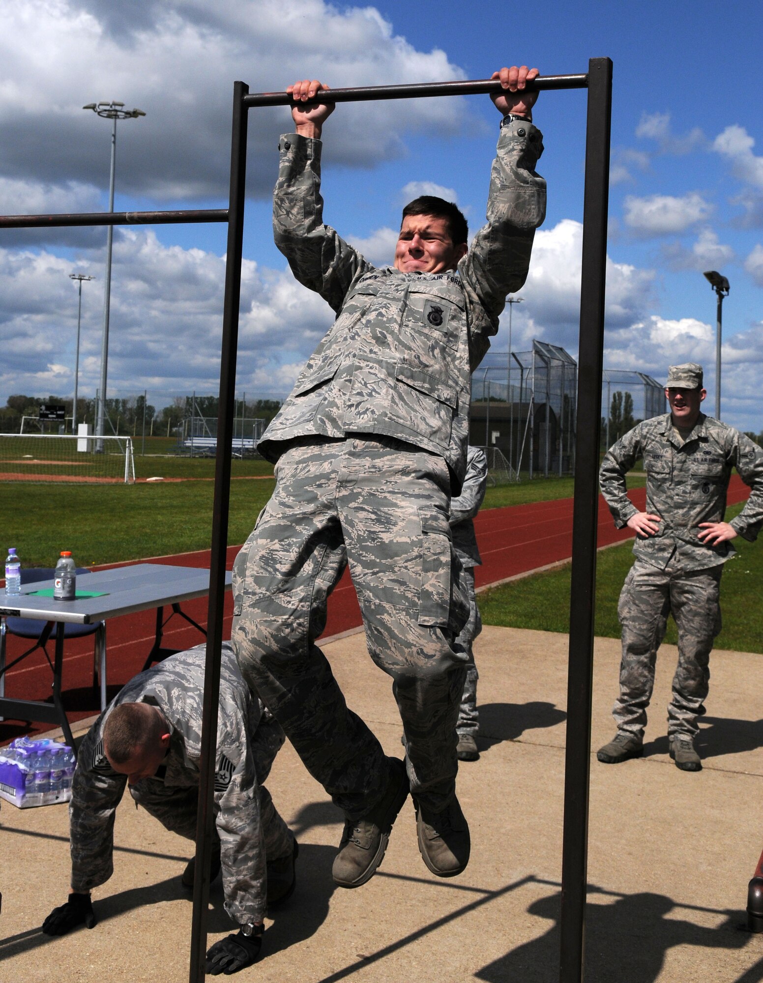 RAF MILDENHALL, England – Airman 1st Class Barry Obrien, 100th Security Forces Squadron, performs a pull-up as Tech. Sgt. Michael Crawford, 100th SFS, does a push-up during the Defender Challenge May 16, 2012, here. The challenge was held in conjunction with the National Police week celebration. (U.S. Air Force photo/Senior Airman Rachel Waller)