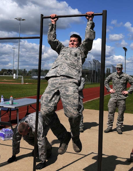 RAF MILDENHALL, England – Airman 1st Class Barry Obrien, 100th Security Forces Squadron, performs a pull-up as Tech. Sgt. Michael Crawford, 100th SFS, does a push-up during the Defender Challenge May 16, 2012, here. The challenge was held in conjunction with the National Police week celebration. (U.S. Air Force photo/Senior Airman Rachel Waller)