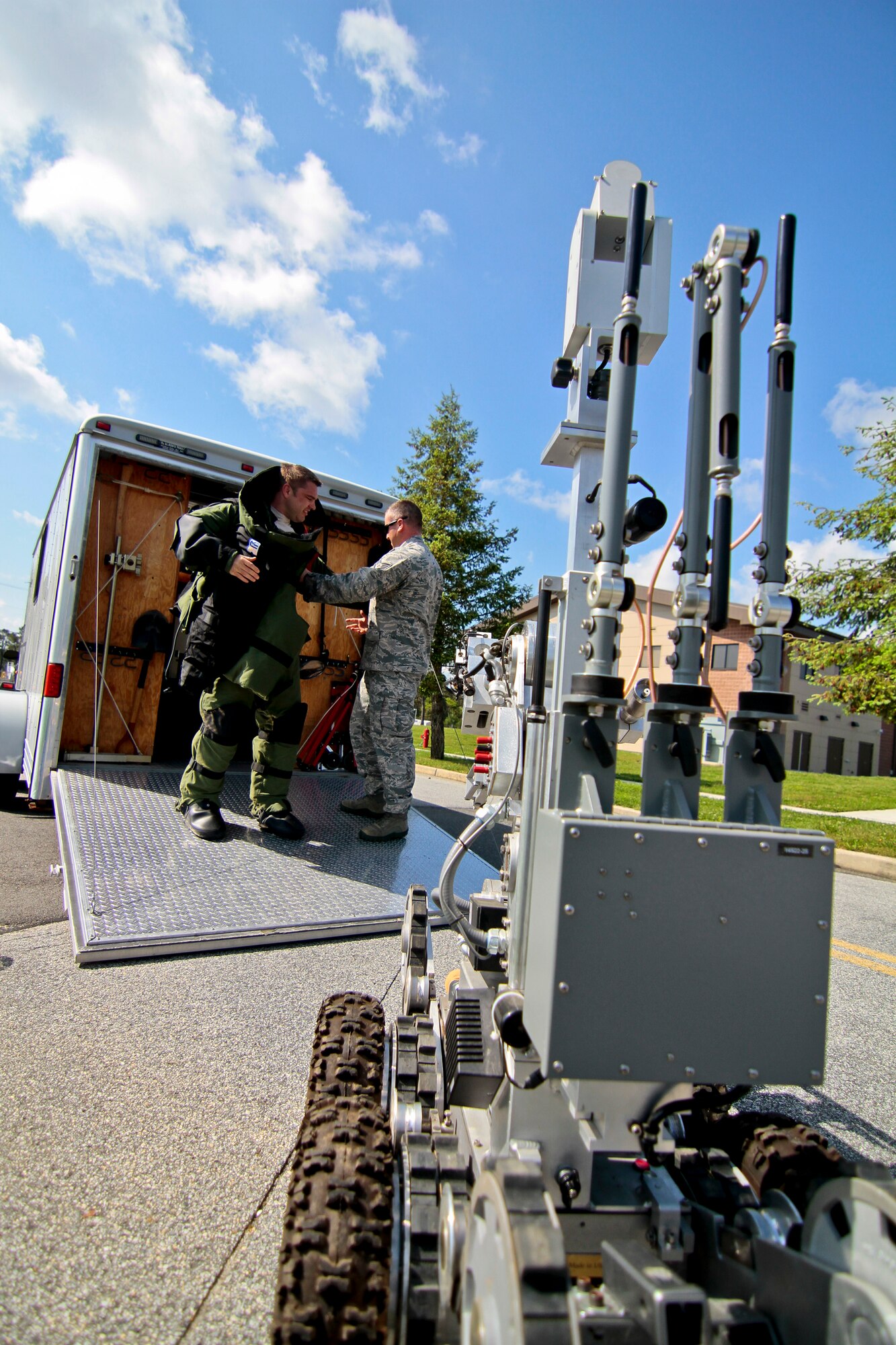 A picture of New Jersey Air National Guardsman Staff. Sgt. John Hurley helping Tech. Sgt. David Niedzwiadek into a bomb suit.