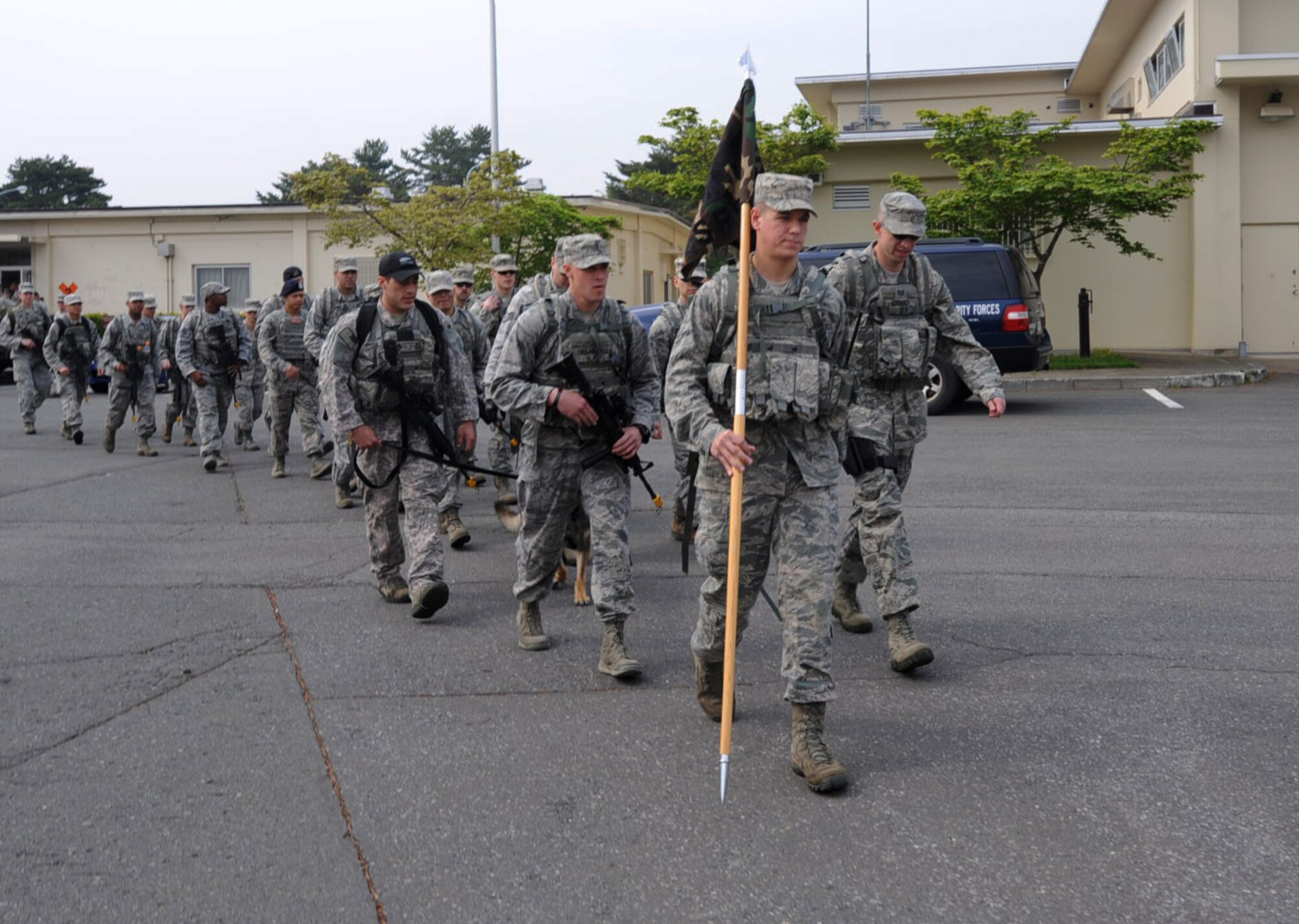 U.S. Airmen from the 35th Security Forces Squadron set off on a march in remembrance of police officers who died in the line of duty during National Police Week at Misawa Air Base, Japan, May 18, 2012. More than 20 SFS members participated in the march around the base perimeter. (U.S. Air Force photo by Airman Kenna Jackson/Released