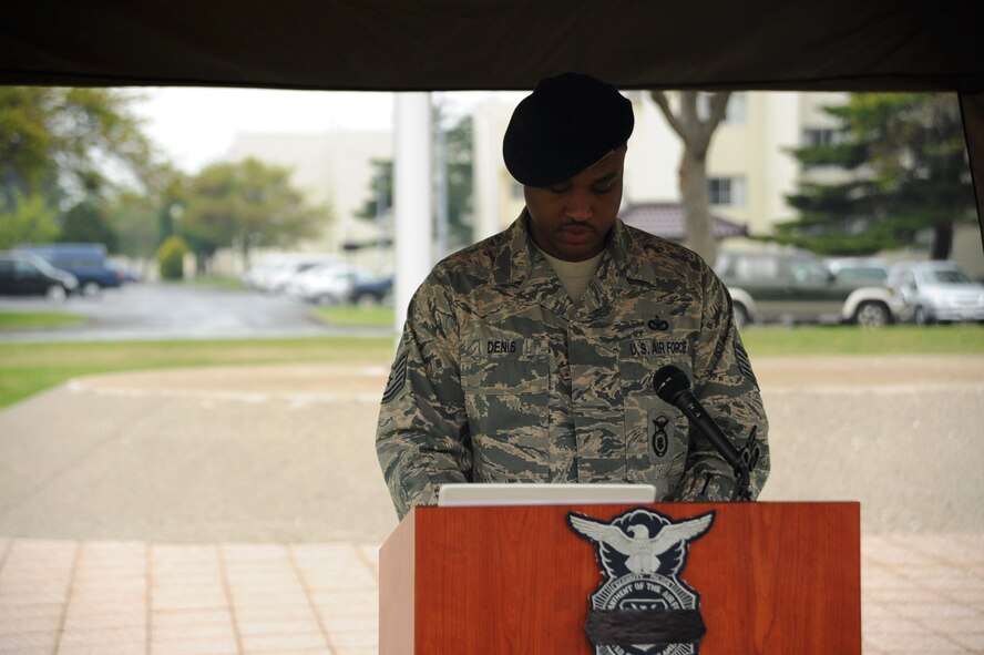 U.S. Air Force Tech. Sgt. Jean-Joseph Denis, 35th Security Forces Squadron confinement administrator, reads off names of police officers who died in the line of duty during a candlelight vigil in support of National Police Week at Misawa Air Base, Japan, May 15, 2012. The vigil is sponsored by the National Law Enforcement Officers Memorial Fund and the Concerns of Police Survivors. (U.S. Air Force photo/Airman Kenna Jackson) 

