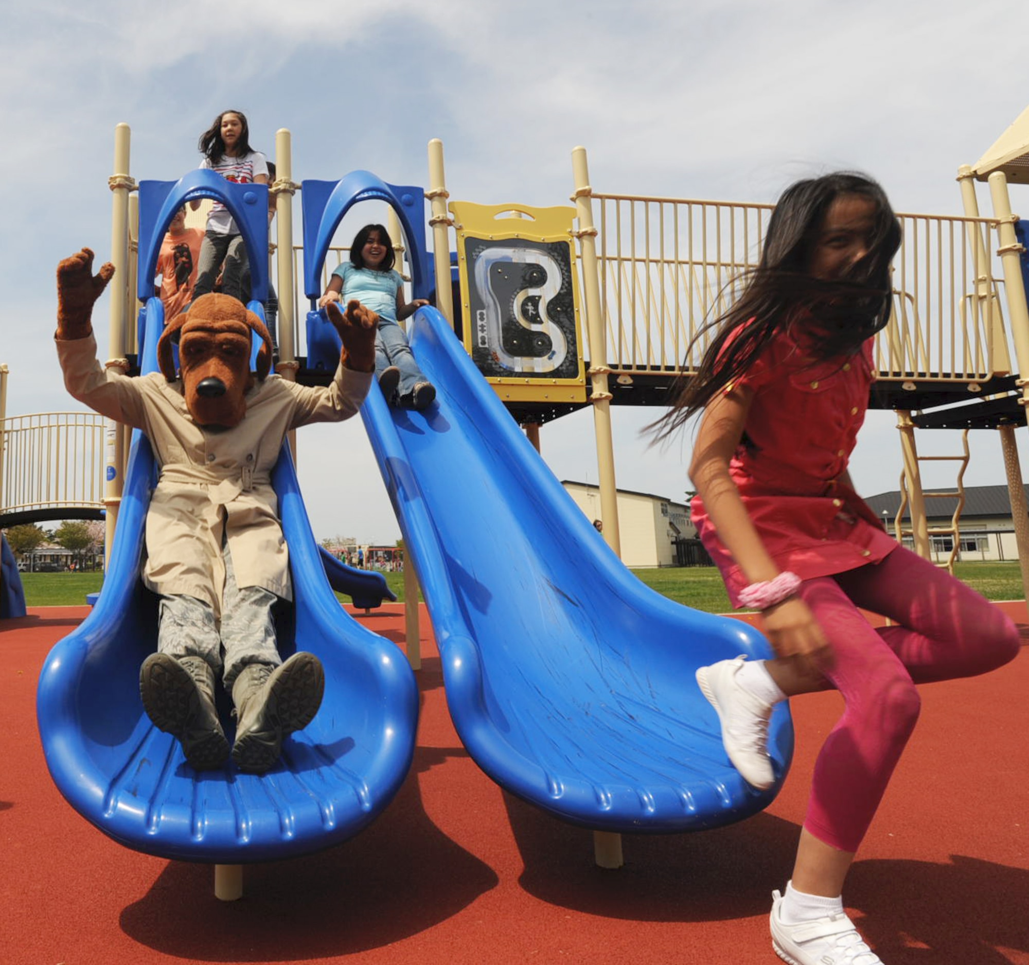 McGruff the Crime Dog slides down a slide with Sollars Elementary School students during recess in support of National Police Week at Misawa Air Base, Japan, May 14, 2012. While spending time with the military children, McGruff reminds children that police officers are a part of their lives. (U.S. Air Force photo by Airman Kenna Jackson/Released)