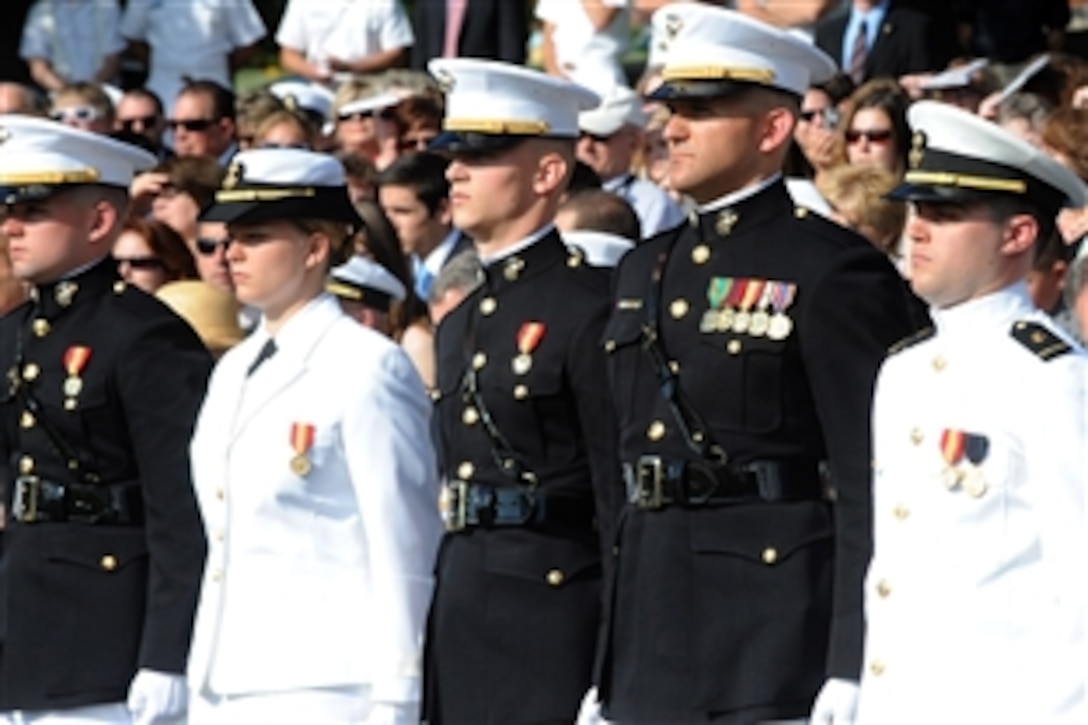 Midshipmen from The George Washington University Naval Reserve Officer Training Corps stand at attention before being commissioned by Navy Adm. James A. Winnefeld Jr., vice chairman of the Joint Chiefs of Staff, during a ceremony at the Iwo Jima Memorial in Arlington, Va., May 18, 2012. More than 200 family and friends joined the Navy and Marine Corps graduates and senior leaders at the event.