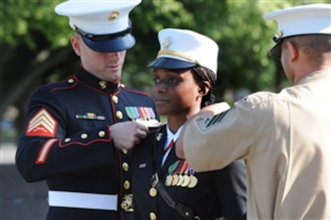 Fellow Marines help to pin on the 2nd Lieutenant rank to University of Maryland ROTC graduate Shari Aletha Peters during a commissioning ceremony at the Iwo Jima Memorial in Arlington, Va., May 18, 2012. Navy Adm. James A. Winnefeld, Jr., vice chairman of the Joint Chiefs of Staff, administered the commissioning oath to the graduating class of 27 midshipmen from The George Washington University Naval Reserve Officer Training Corps. 