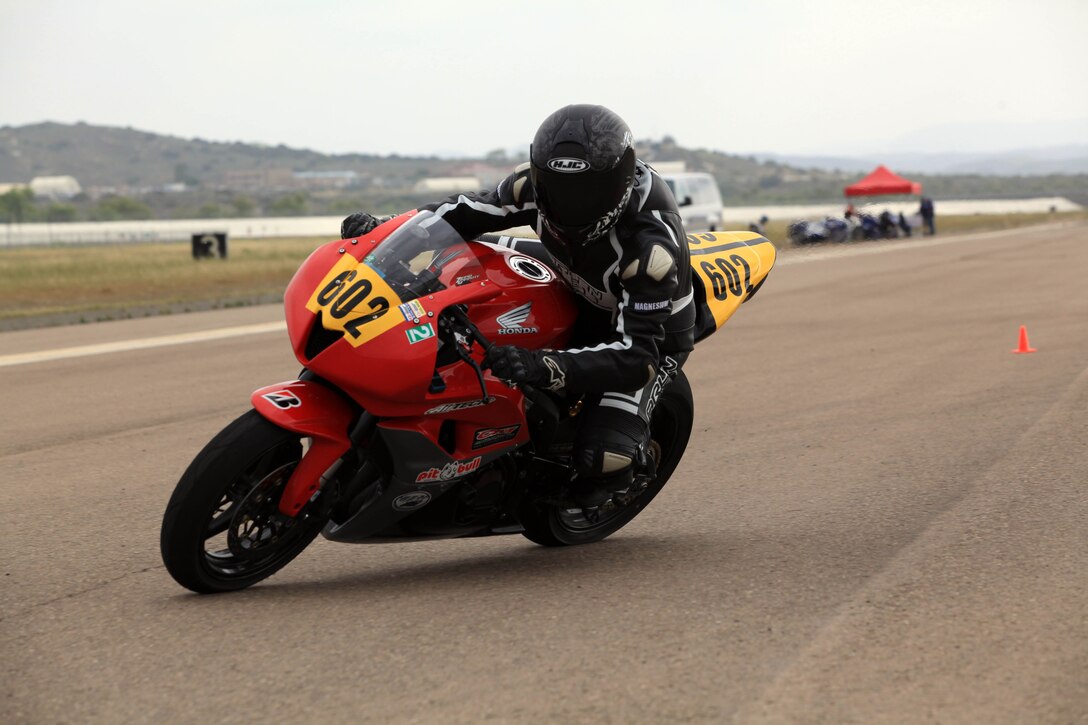 A Marine from 1st Marine Division, Marine Air Group 39 takes a tight turn on the Motorcycle Track Day portion of Semper Ride's Fun Day on the Runway at the Marine Corps Air Station Camp Pendleton, May 18.