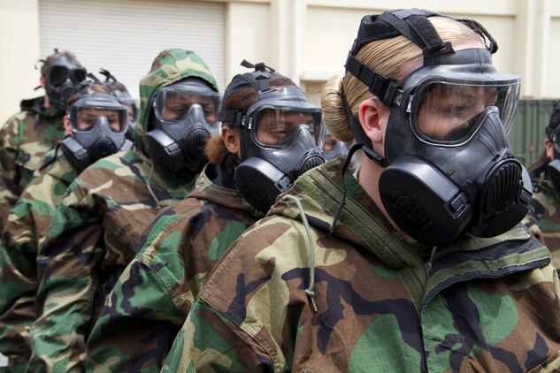 Kate A. West and other U.S. Marine spouses line up to enter the gas chamber during Jane Wayne Day aboard Marine Corps Air Station Iwakuni, Japan, May 19. Jane Wayne Day lets family members experience parts of Marine Corps life to provide shared experience and understanding.