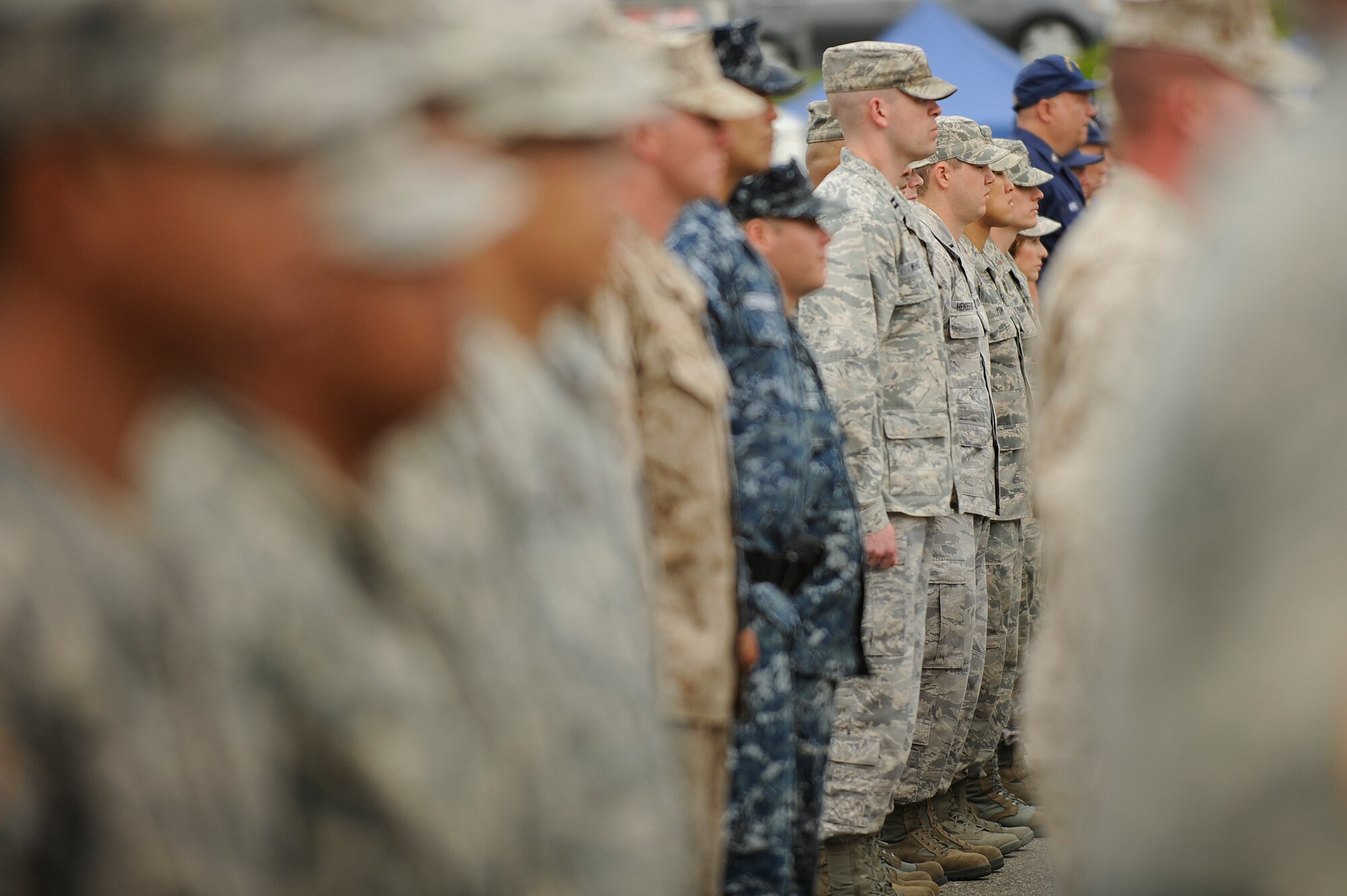TORRANCE, Calif. -- Team V and Los Angeles Air Force Base Airmen stand in a formation at a Reveille Ceremony during the 53rd Annual Armed Forces Day here Saturday, May 19, 2012. More than 200 Soldiers, Sailors, Airmen, Marines and Coast Guardsmen attended the ceremony at the military exhibits area in the Del Amo parking lot. (U.S. Air Force photo/Staff Sgt. Levi Riendeau) 

 