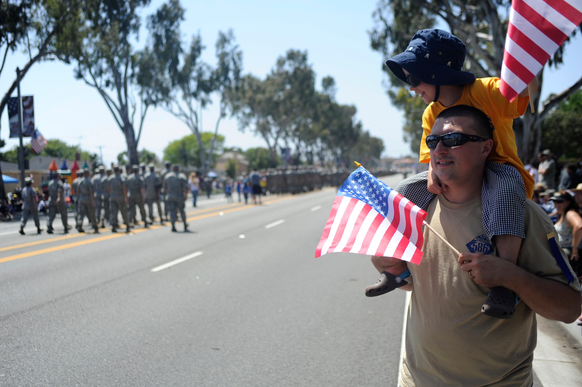 TORRANCE, Calif. -- A father and son gaze at the participants during the 53rd Annual Armed Forces Day Parade here Saturday, May 19, 2012. Approximately 325 Airmen from Vandenberg Air Force Base, Los Angeles AFB and Edwards AFB marched in the parade of more than 100,000 onlookers. (U.S. Air Force photo/Staff Sgt. Andrew Satran) 

