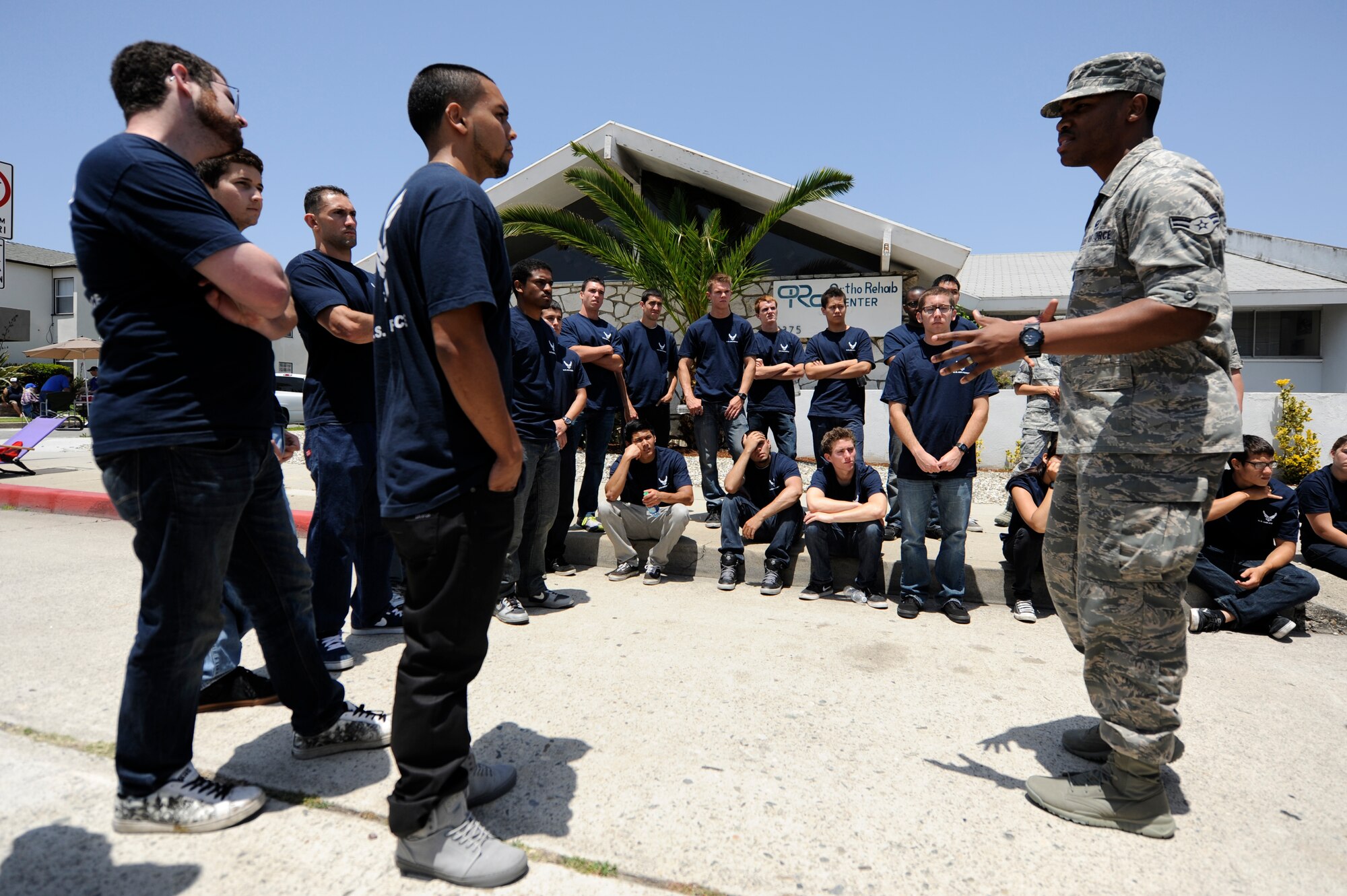 TORRANCE, Calif. -- Airman 1st Class Darian Tannis, 30th Space Wing Judge Advocate military justice paralegal, mentors Air Force delayed enlistees prior to the parade during the 53rd Annual Armed Forces Day here Saturday, May 19, 2012. More than 150 Soldiers, Sailors, Airmen, Marines and Coast Guardsmen attended the ceremony at the military exhibits area in the Del Amo parking lot. (U.S. Air Force photo/Staff Sgt. Andrew Satran) 

