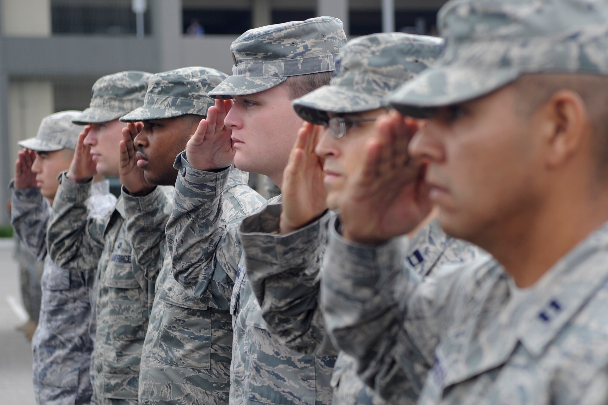TORRANCE, Calif. -- Team V Airmen salute at a reveille ceremony during the 53rd Annual Armed Forces Day here Saturday, May 19, 2012. More than 200 Soldiers, Sailors, Airmen, Marines and Coast Guardsmen attended the ceremony at the military exhibits area in the Del Amo parking lot. (U.S. Air Force photo/Staff Sgt. Andrew Satran) 

 