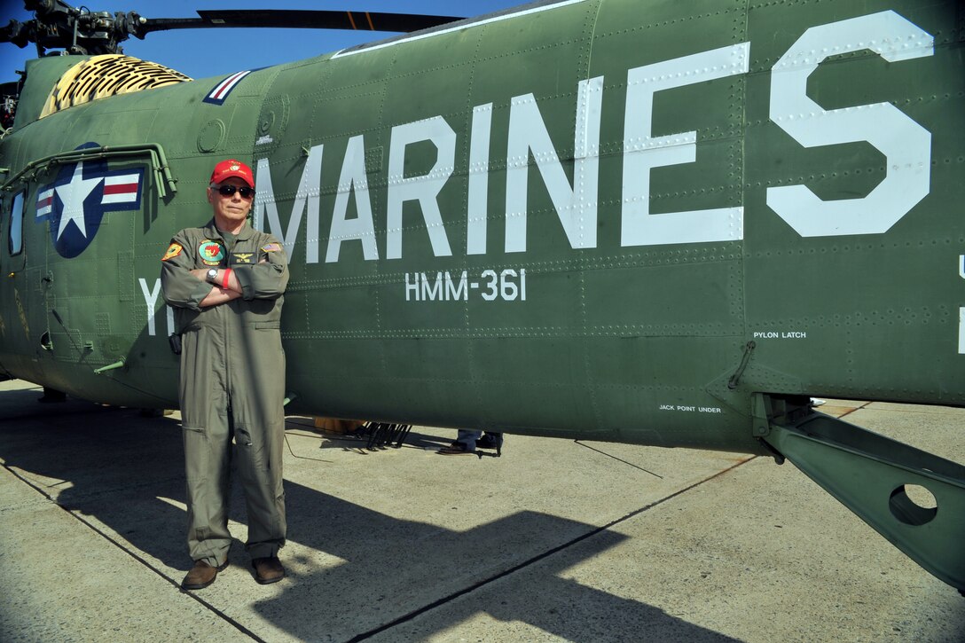 Marine Corps Captain Ben Cascio (Ret.) stands beside an HMM-361 during the Joint Service Open House at Base Andrews, Md., May 19. The HMM-361 proved to be the work horse of the United States Marine Corp during the Vietnam War; being used for various combat support missions from 1963-1970.The modern Marine Corp encompasses an array of air craft vital to completing the U. S. Marine Corp mission. (U.S. Air Force photo /Tech. Sgt. Raymond Mills) 