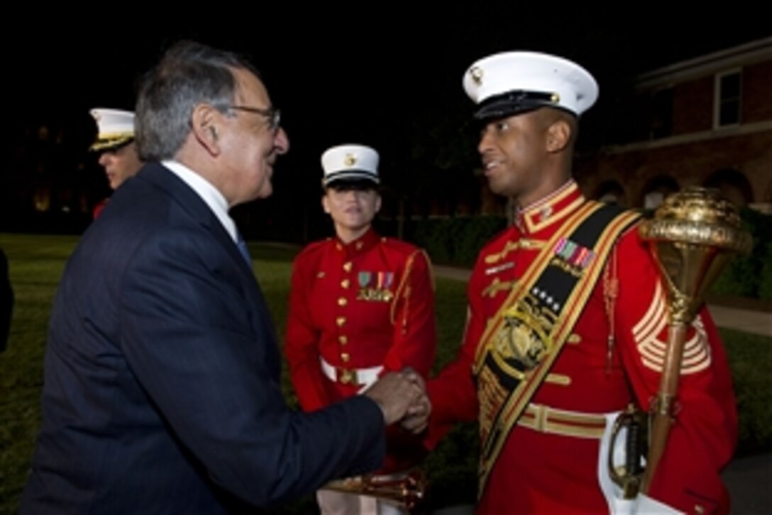 Defense Secretary Leon E. Panetta thanks the director of the "Commandant's Own" Drum and Bugle Corps after an evening parade in the secretary's honor at Marine Barracks Washington May 18, 2012, in Washington D.C.  
