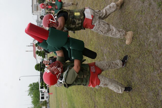 Marine spouses fight with pugil sticks during Jane Wayne Day aboard Marine Corps Air Station Iwakuni, Japan, May 19. Jane Wayne Day lets family members experience parts of Marine Corps life to provide shared experience and understanding.