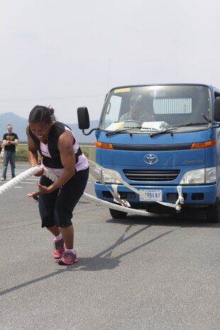 Anita Clayton, a 131 pound and above competitor, pulls a two and a half truck during the 2012 Strongman Competition at Penny Lake Field Here May 19, 2012. The competition consisted of several events including a Farmer’s Walk, tire flip, barrel press and truck pull. A total of 10 competitors, three males and seven females, participated in two classes for females and three for males.