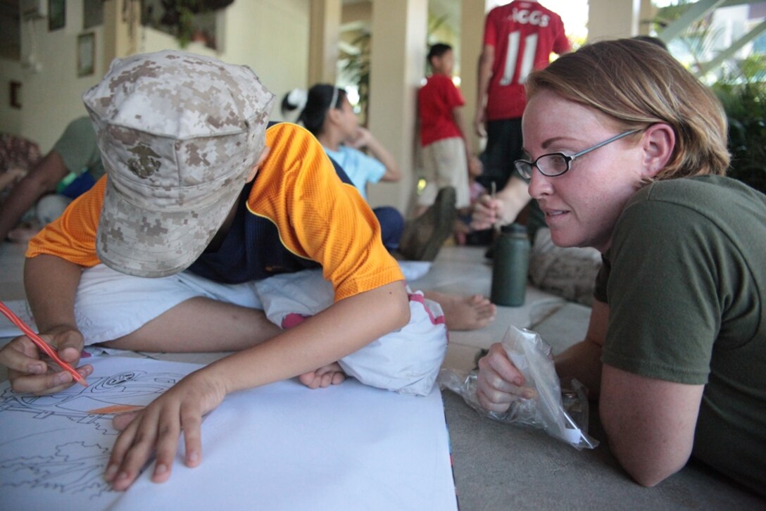 Gunnery Sgt. Jennifer E. Holt draws during a volunteer project at an orphanage here May 19. Holt serves with the 11th Marine Expeditionary Unit's command element. The unit embarked USS Makin Island, USS New Orleans and USS Pearl Harbor in San Diego Nov. 14, beginning a seven-month deployment to the Western Pacific, Horn of Africa and Middle East regions.