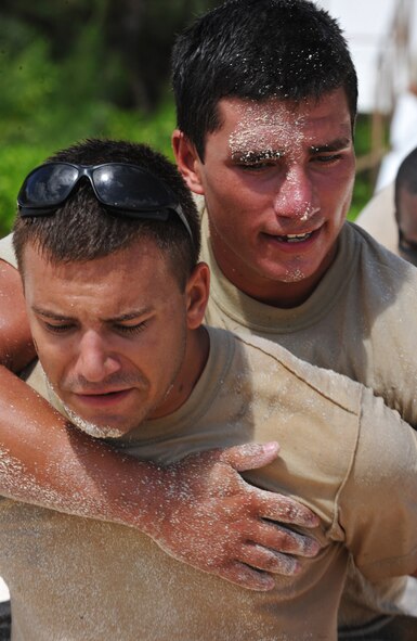ANDERSEN AIR FORCE BASE, Guam—Two Airmen from the 554 Red Horse Squadron perform buddy carries for the final event of the Warrior Challenge May 16. Six first responder teams participated in the challenge. (U.S. Air Force photo by Senior Airman Benjamin Wiseman/Released)