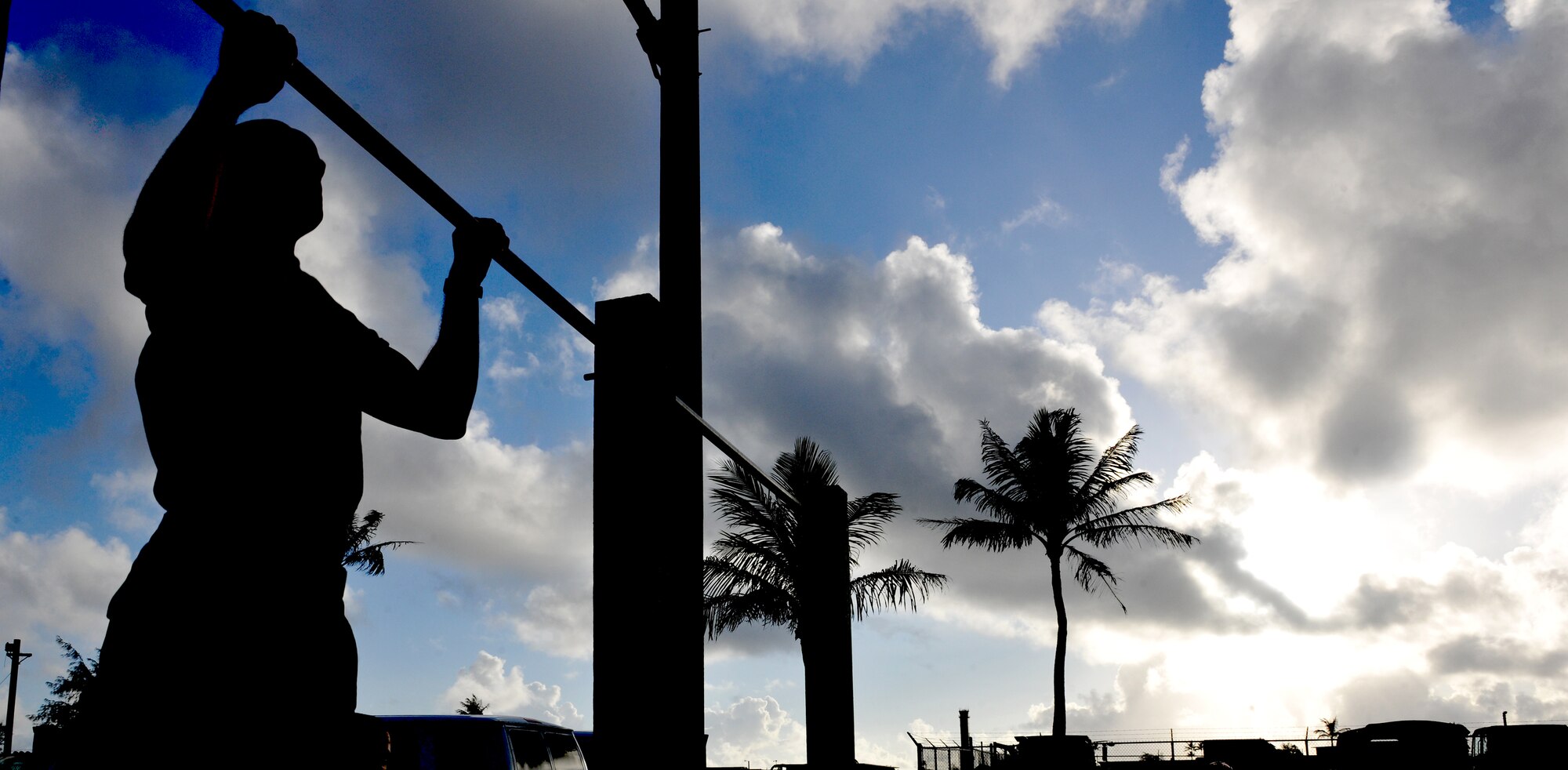 ANDERSEN AIR FORCE BASE, Guam—A participant of the Warrior Challenge during National Police Week performs pull-ups May 16. Performing 100 pull-ups as a team was the starting station each first responder team had to endure during the Challenge. (U.S. Air Force photo by Senior Airman Benjamin Wiseman/Released)
