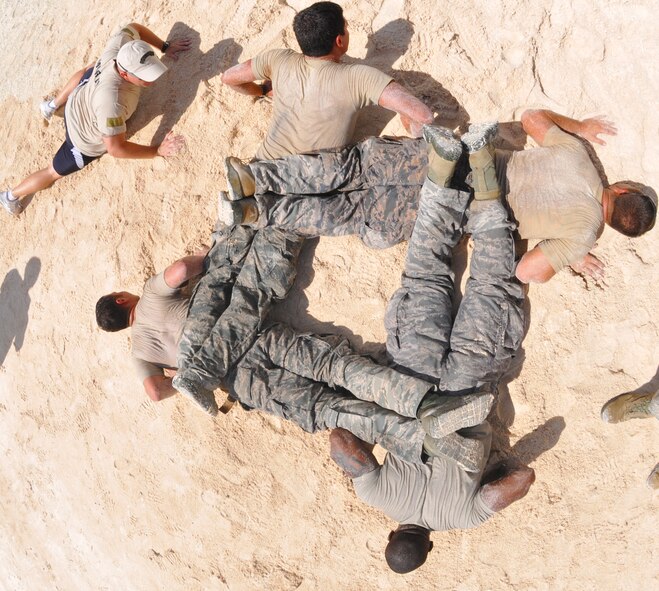 ANDERSEN AIR FORCE BASE, Guam— Members of the 554th Red Horse Squadron perform fire team push-ups as part of the Warrior Challenge during National Police Week May 16. The last portion of the challenge was named “Team Pain,” and a separate award was given to the team with the most repetitions. (U.S. Air Force photo by Senior Airman Benjamin Wiseman/Released)