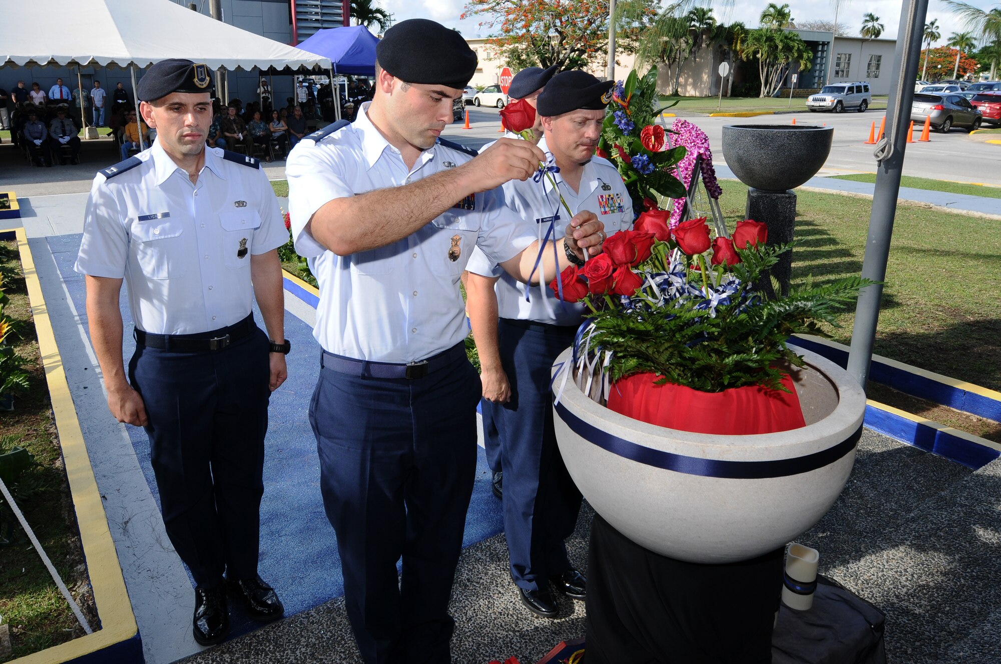ANDERSEN AIR FORCE BASE, Guam – Capt. David Bullock, 736th Security Forces Duty Officer places in a rose, in remembrance of a fallen security forces officer, during the Hagatna National Police Week wreath-laying ceremony May 15. National Police week is an annual celebration that features different events to educate the community and honor fallen officers around the world. (U.S. Air Force photo by Senior Airman Carlin Leslie/Released)