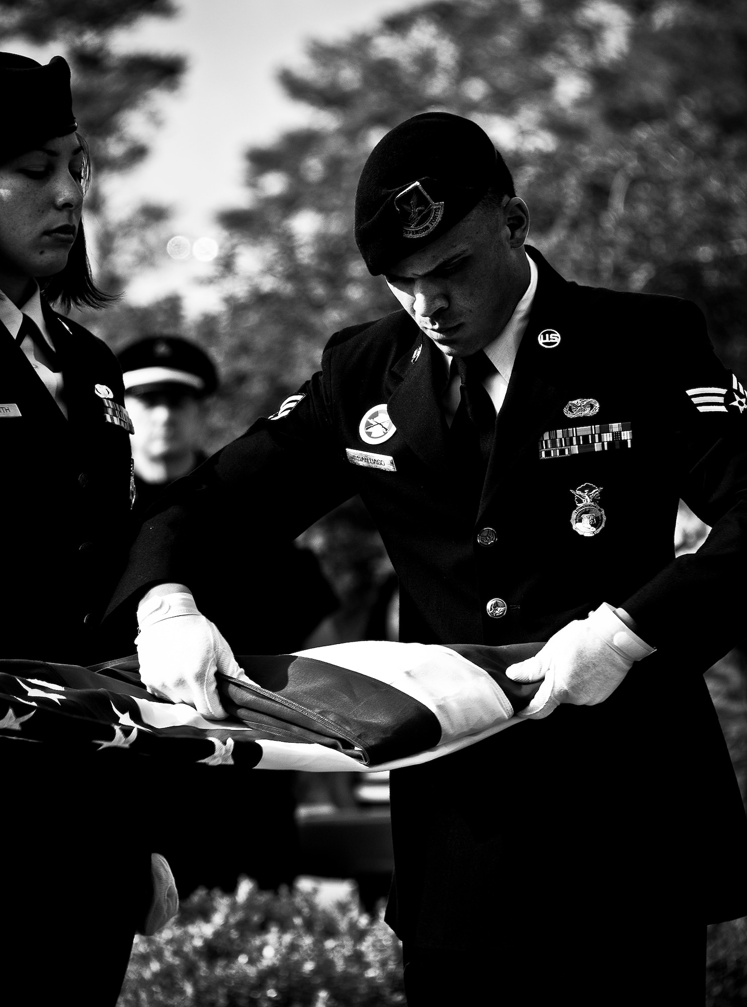 Senior Airman Kenneth Santiago, a 96th Security Forces Squadron Airman, folds the flag during the remembrance and retreat ceremony at the All Wars Memorial May 17 at Eglin Air Force Base, Fla.  The ceremony formally closed Police Week activities. Chief of the Niceville Police Department, David Popwell, a former security forces Airman, was the guest speaker at the event.  During his speech, he donned the black beret to honor his fellow security forces Airmen still serving.  (U.S. Air Force photo/Samuel King Jr,)