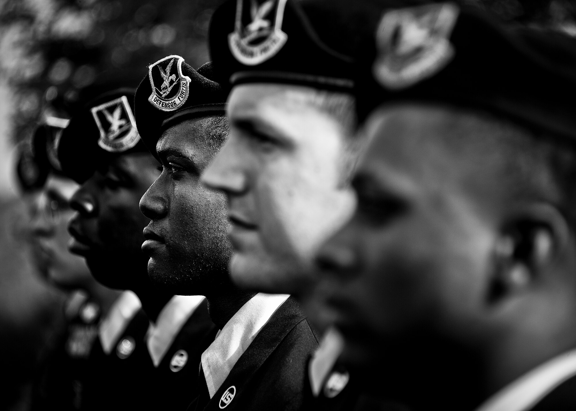 A row of  Airmen from the 96th Security Forces Squadron stand in formation during a remembrance and retreat ceremony at the All Wars Memorial May 17 at Eglin Air Force Base, Fla.  The ceremony formally closed Police Week activities. Chief of the Niceville Police Department, David Popwell, a former security forces Airman, was the guest speaker at the event.  During his speech, he donned the black beret to honor his fellow security forces Airmen still serving.    (U.S. Air Force photo/Samuel King Jr,)