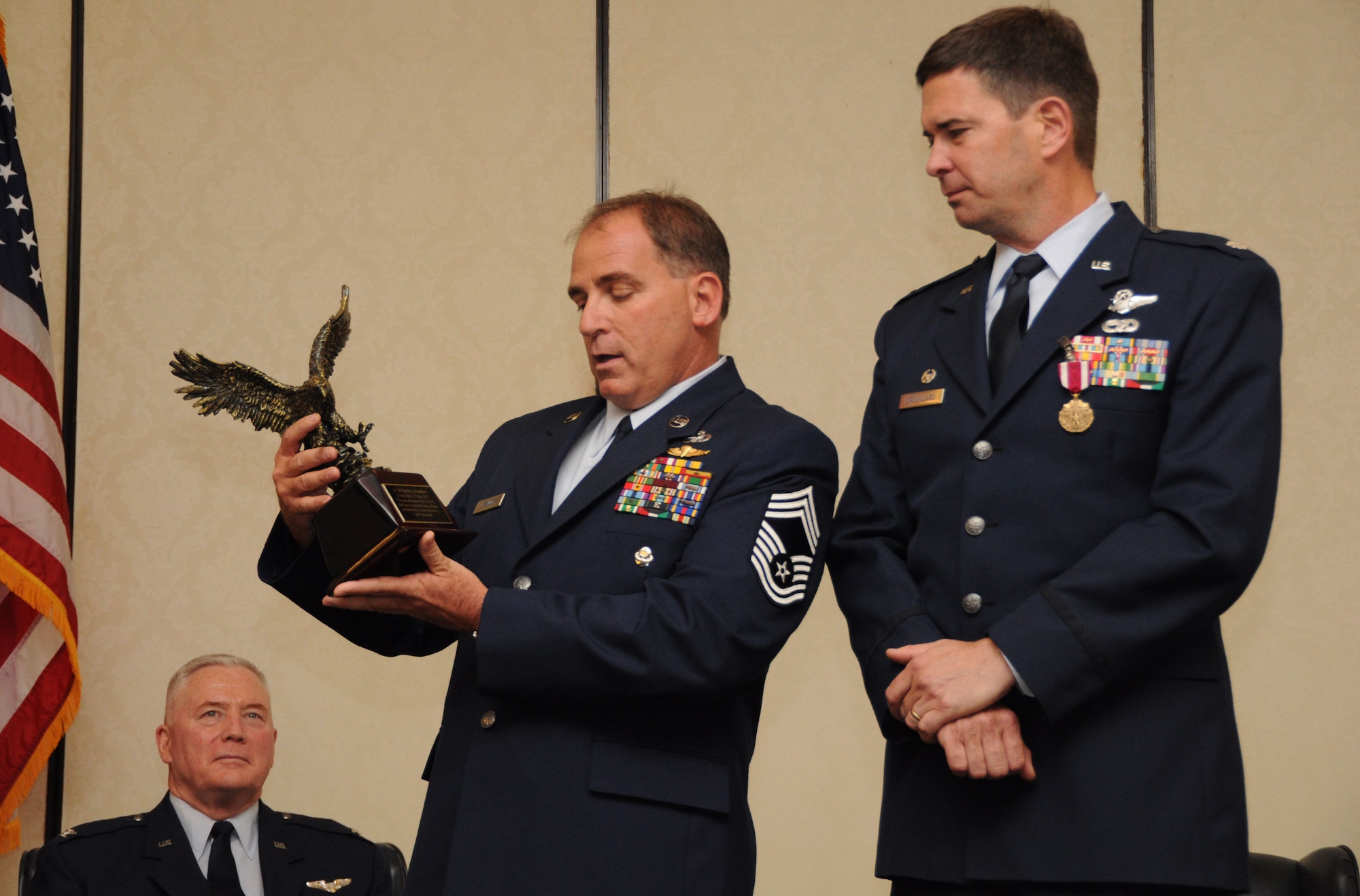 Chief Master Sgt. Brad Levander recognizes the accomplishments of Lt. Col. Charles Drouillard with an honorary eagle statue during Colonel Drouillard’s retirement ceremony May 19, 2012 at Joint Base Charleston, S.C. Chief Levander is the senior Air Reserve Technician with 81st Aerial Port Squadron, and Colonel Drouillard’s retirement closed out 25 years of distinguished military service in the U.S. Air Force. (U.S. Air Force Photo/Staff Sgt. Shane Ellis)