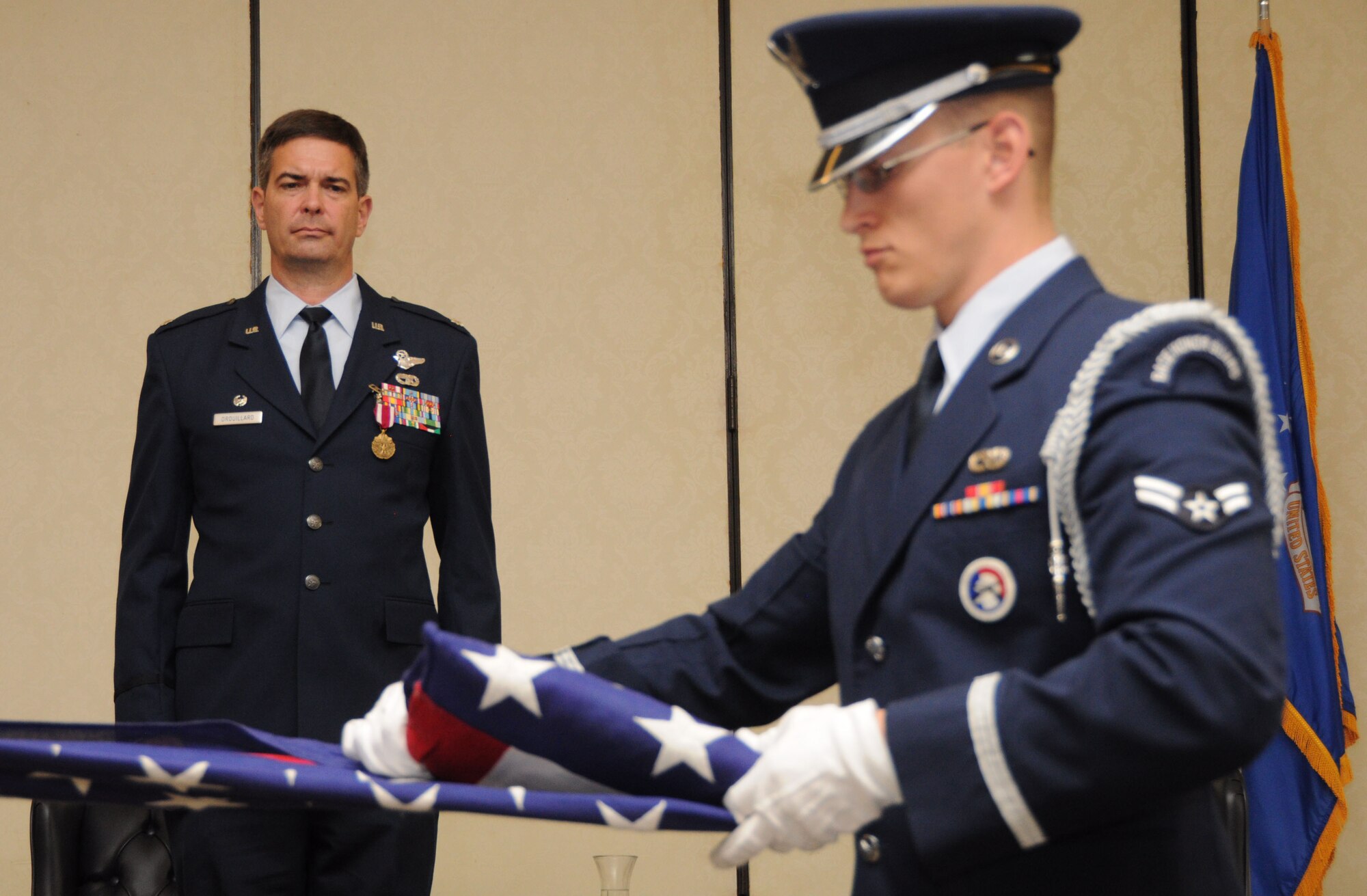 Lt. Col. Charles Drouillard watches as his retirement flag is folded by an Airmen with the Joint Base Charleston, S.C. honor guard May 19, 2012 at Joint Base Charleston, S.C. Colonel Drouillard’s retirement closed out 25 years of distinguished military service in the U.S. Air Force. (U.S. Air Force Photo/Staff Sgt. Shane Ellis)