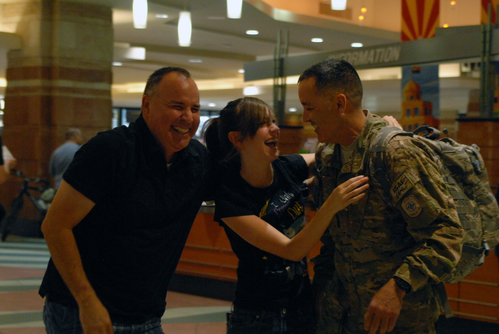 Family members welcome home Lt. Col. Paul Aguirre, 161st Air Refueling Wing chief of staff, at Phoenix Sky Harbor International Airport May 6, 2012, after his seven-month deployment to Kandahar, Afghanistan. (U.S. Air Force photo by Tech. Sgt. Susan Gladstein/Released)