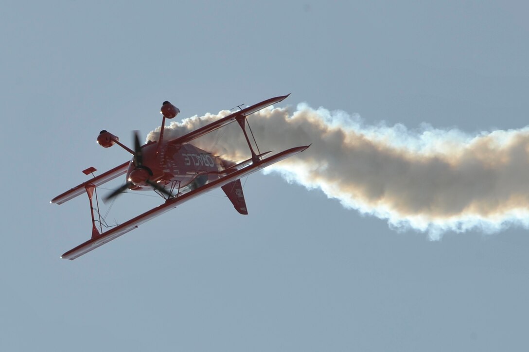 Sean D. Tucker from team Oracle performs aerial acrobatics in his custom biplane, May 19, 2012 at Joint Base Andrews, Md. This year's Joint Service Open House celebrates the Centennial of Marine Corps Aviation. JSOH affords the public the opportunity to meet the men and women of the Armed Forces while viewing more than 100 static displays and 19 aerial demonstration teams.(U.S. Air Force photo by Senior Airman Perry Aston)